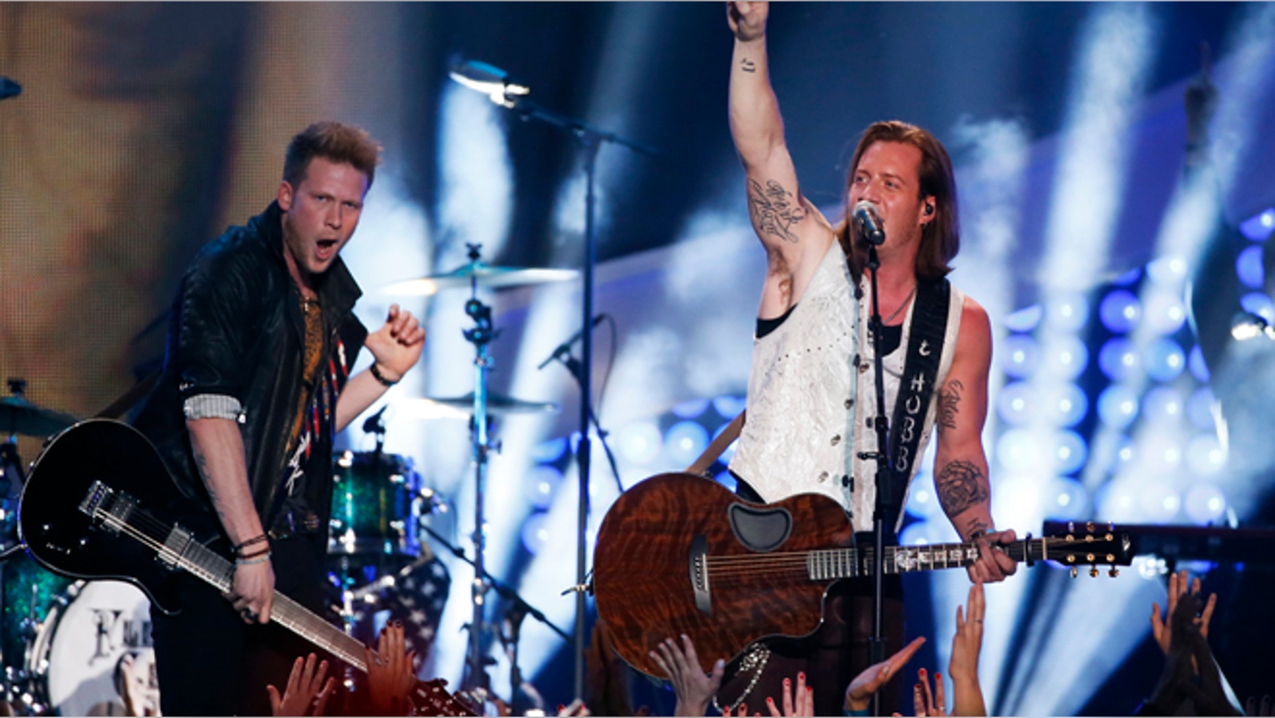 Brian Kelley (L) and Tyler Hubbard of Florida Georgia Line perfom "Stay" during the 4th annual American Country Awards in Las Vegas, Nevada December 10, 2013. REUTERS/Lucy Nicholson (UNITED STATES - Tags: ENTERTAINMENT) - RTX16DAR