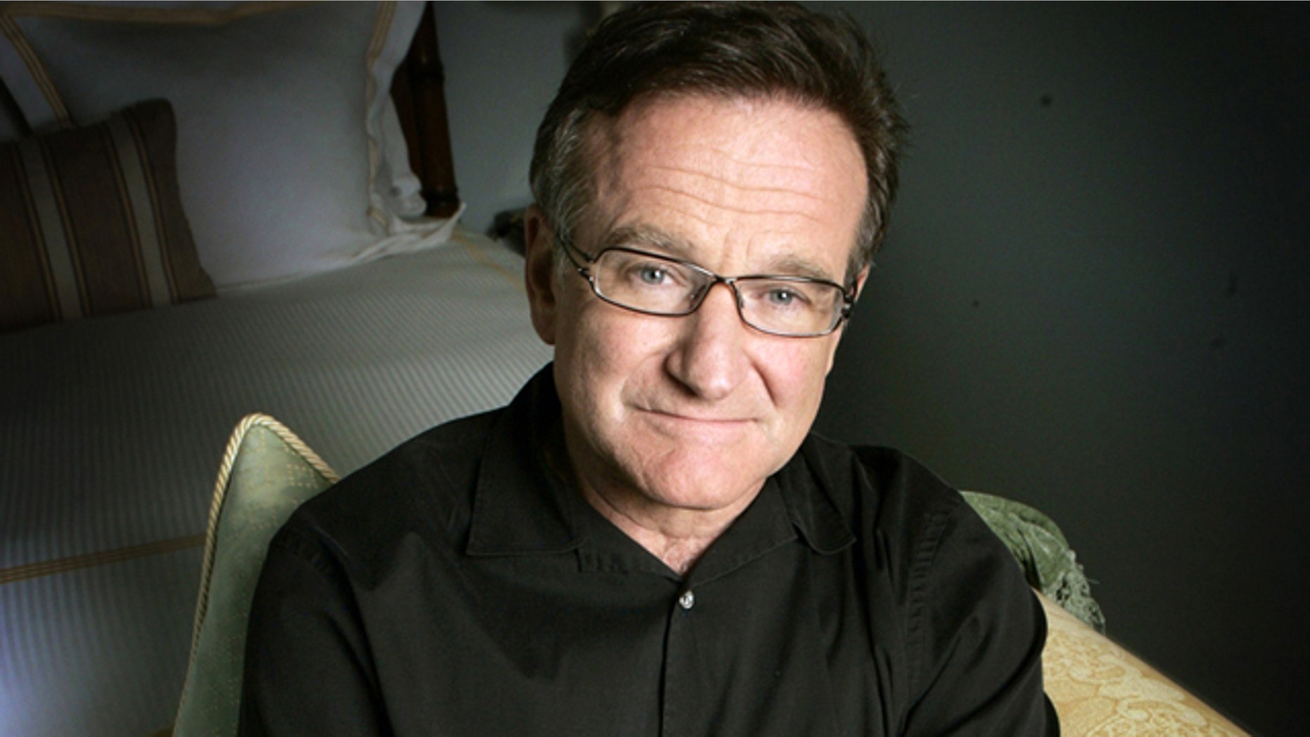 FILE - This June 15, 2007 file photo shows actor and comedian Robin Williams posing for a photo in Santa Monica, Calif. Williams, whose free-form comedy and adept impressions dazzled audiences for decades, died Monday, Aug. 11, 2014, in an apparent suicide. Williams was 63. (AP Photo/Reed Saxon, File)