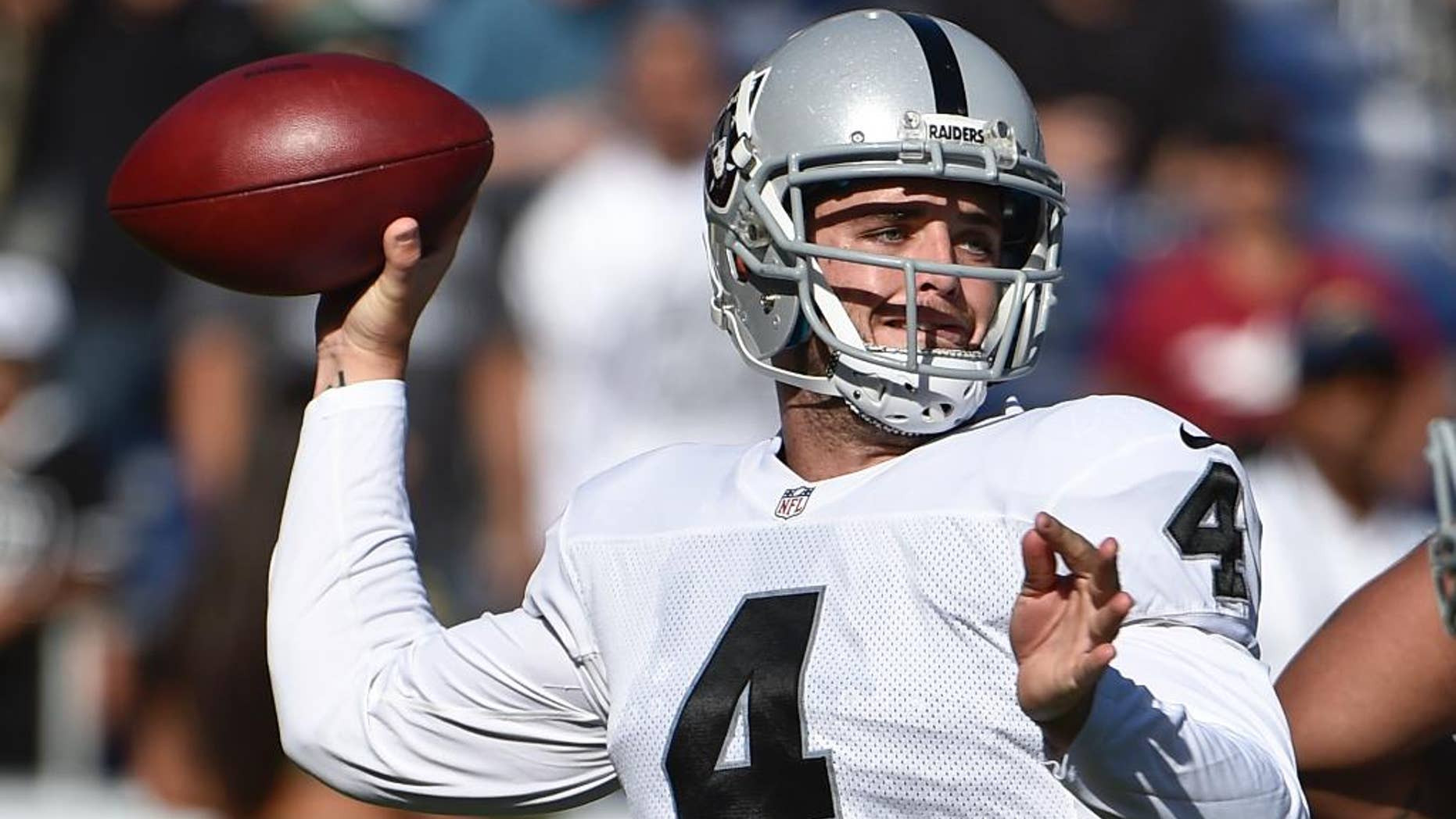 Oakland Raiders quarterback Derek Carr struggles against the pass rush of San Diego Chargers defensive end Corey Liuget during the first half an NFL football game Sunday, Nov. 16, 2014, in San Diego. (AP Photo/Gregory Bull)