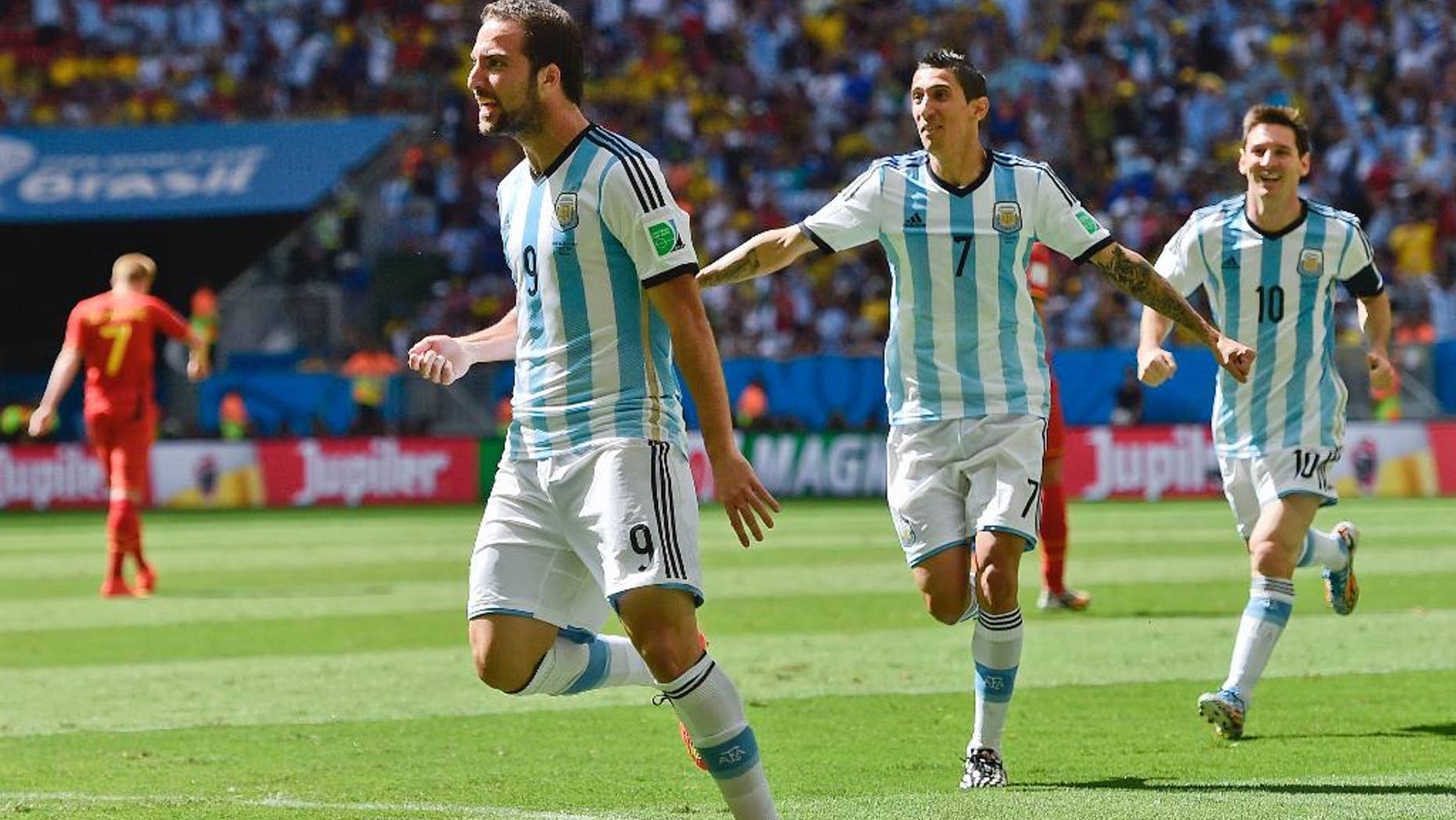 Argentina's Gonzalo Higuain, left, celebrates with Angel di Maria and Lionel Messi, right, after scoring the opening goal during the World Cup quarterfinal soccer match between Argentina and Belgium at the Estadio Nacional in Brasilia, Brazil, Saturday, July 5, 2014. (AP Photo/Martin Meissner)