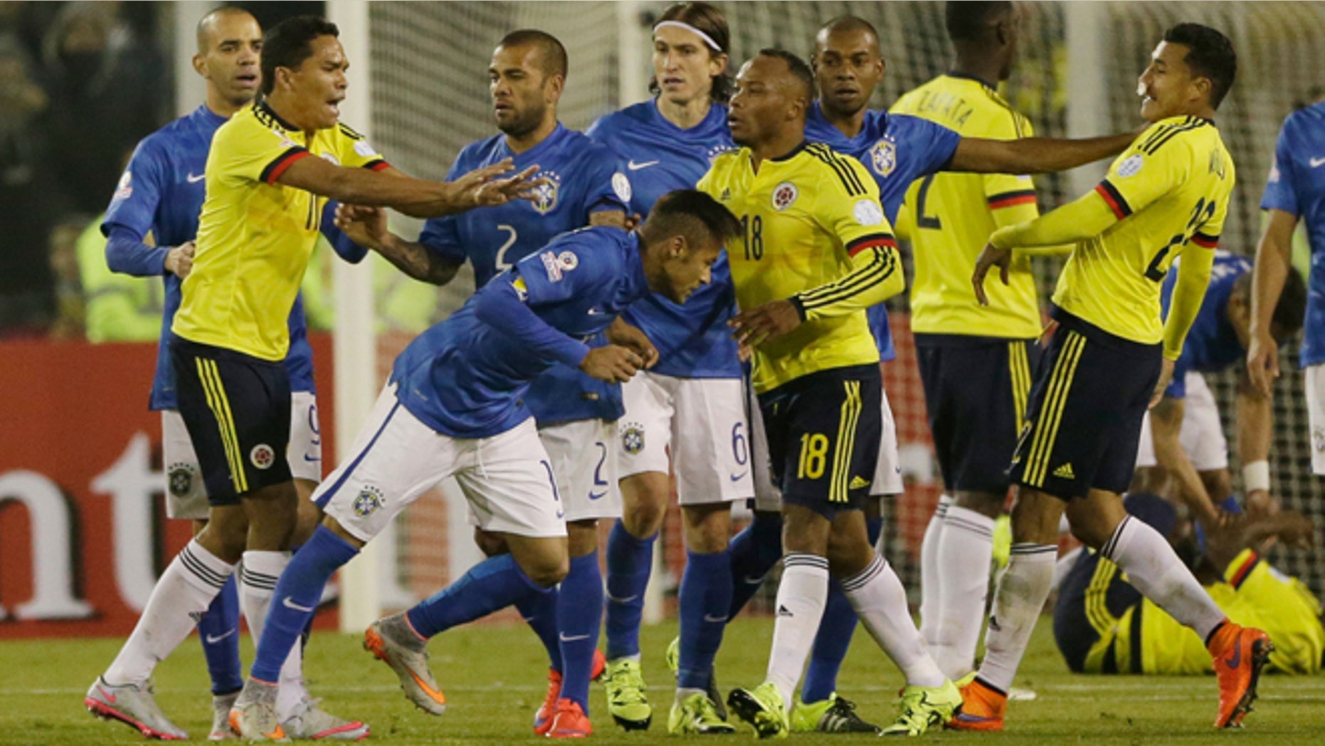 Colombia's Carlos Bacca, second left, pushes Brazil's Neymar, center right, at the end of the Copa America Group C soccer match at the Monumental stadium in Santiago, Chile, Wednesday, June 17, 2015. Colombia won the match 1-0 and Bacca and Neymar where both sent off with a red card at the end of the match. (AP Photo/Ricardo Mazalan)