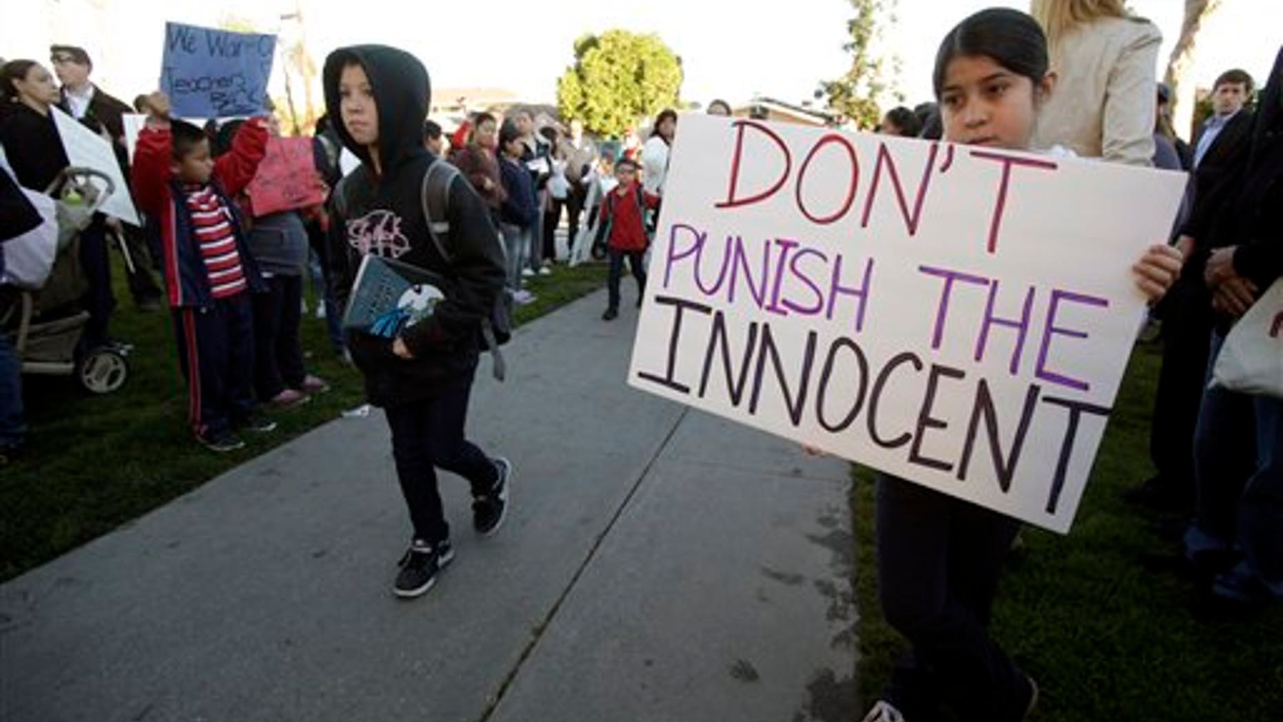 Feb. 9: Nine-year-old Ruby Garduno, right, holds a sign as students enter Miramonte Elementary School in Los Angeles.