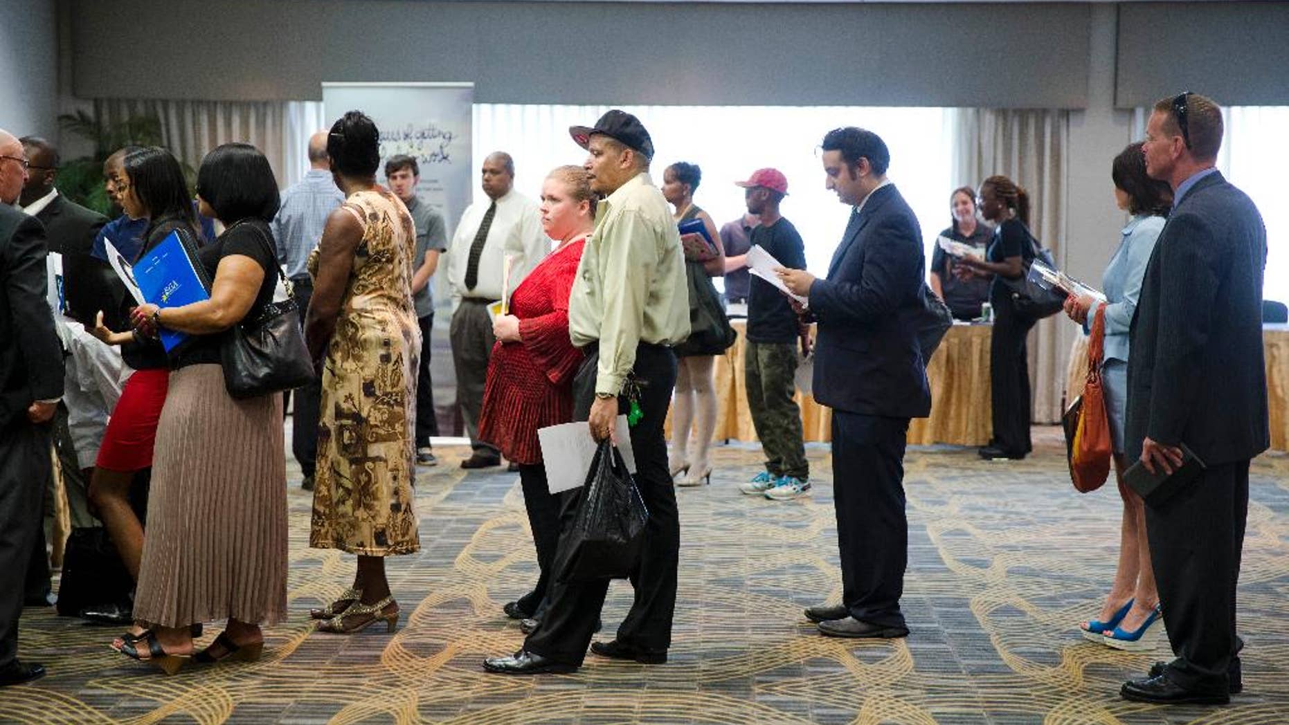 In this June 23, 2014 photo, people wait in line to meet with recruiters during a job fair in Philadelphia. The Labor Department reports on the number of people who applied for unemployment benefits last week on Thursday, Aug. 21, 2014. (AP Photo/Matt Rourke)