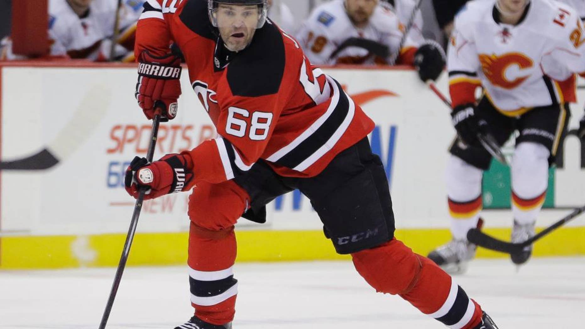 New Jersey Devils right wing Jaromir Jagr, of the Czech Republic, skates against the Calgary Flames during the second period of an NHL hockey game, Wednesday, Feb. 25, 2015, in Newark, N.J. (AP Photo/Julio Cortez)