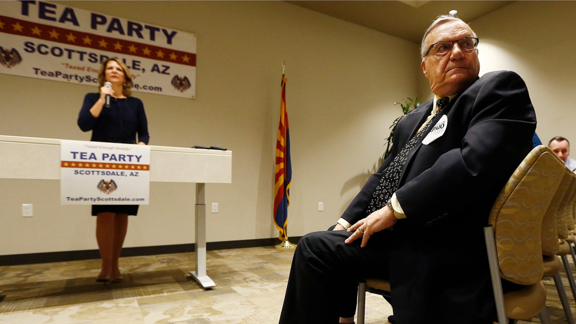 May 17: , Republican Senate candidates Kelli Ward, left, and former Maricopa Country Sheriff Joe Arpaio, right, listen to a question from the audience as the candidates talk about their platform policies at a Scottsdale Tea Party event.