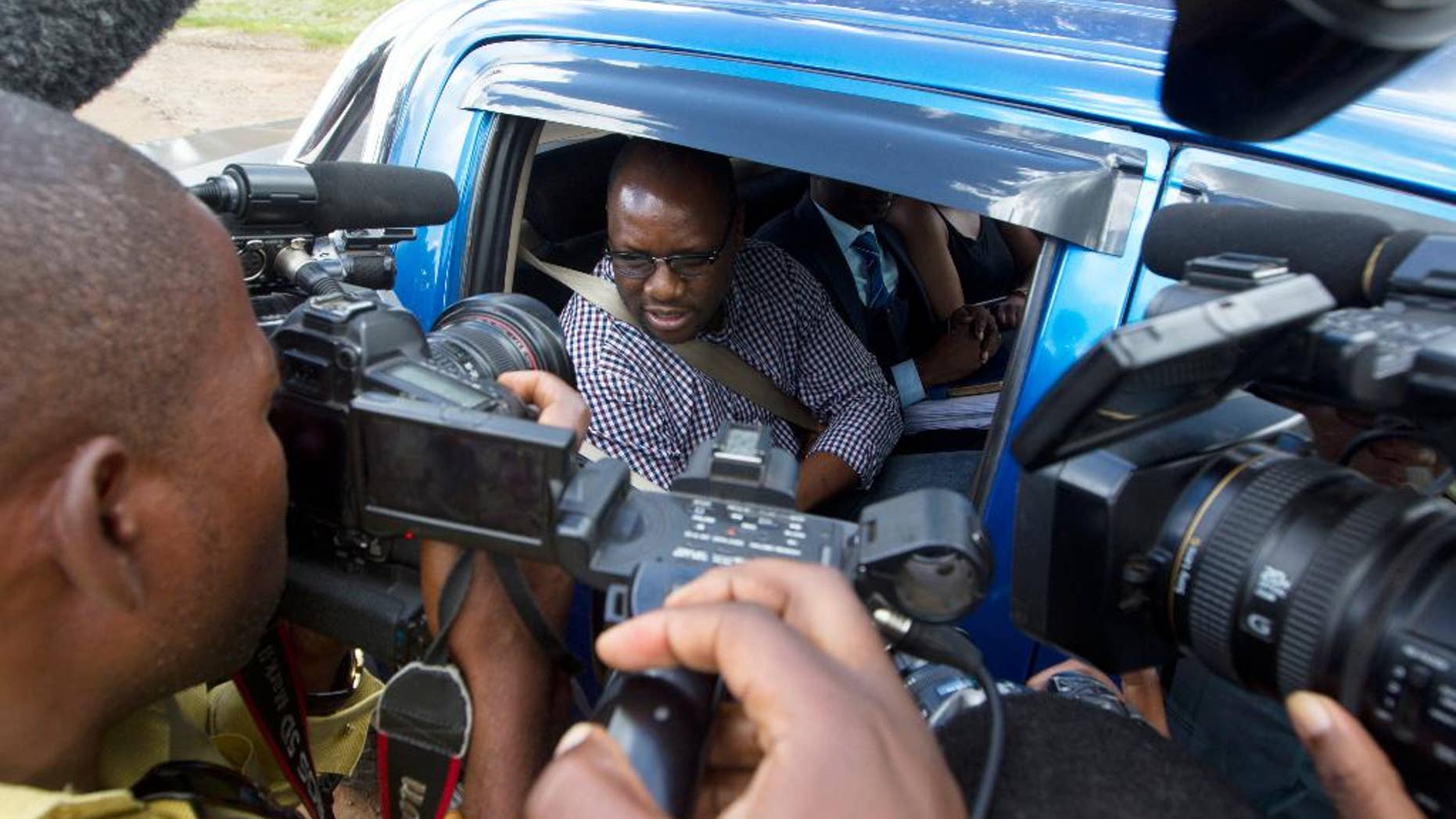 Zimbabwean Pastor Evans Mawarire talks to the media following his release from Chikurubi Maximum Prison on the outskirts of Harare, Thursday, Feb, 9, 2017. The trail was postponed and Mawarire released on bail, accused of subversion for protests against the government of President Robert Mugabe. (AP Photo/Tsvangirayi Mukwazhi)