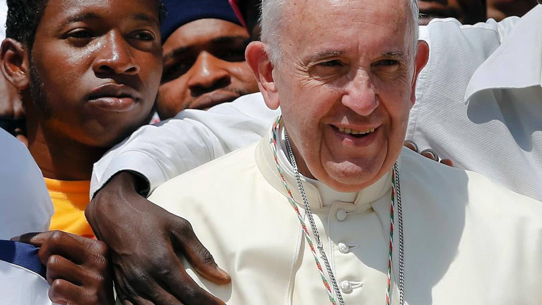 Pope Francis poses for a family picture with migrants of the San Francesco association at the end of his weekly general audience in St. Peter's Square at the Vatican, Wednesday, June 8, 2016. (AP Photo/Fabio Frustaci)