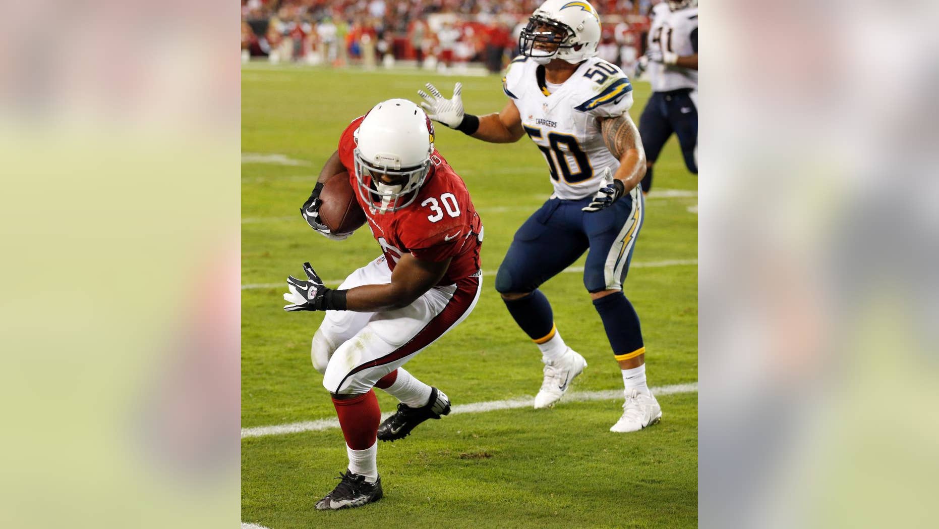 Arizona Cardinals running back Stepfan Taylor (30) pulls in a touchdown pass as San Diego Chargers inside linebacker Manti Te'o (50) stands near during the second half of an NFL football game, Monday, Sept. 8, 2014, in Glendale, Ariz. (AP Photo/Ross D. Franklin)