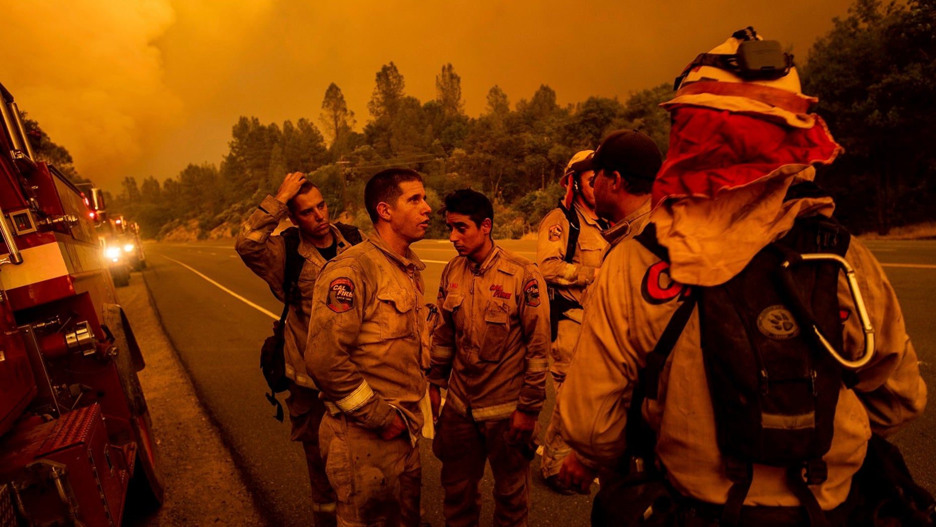 Firefighters discuss plans while battling the Carr Fire in Shasta, Calif., on Thursday, July 26, 2018.