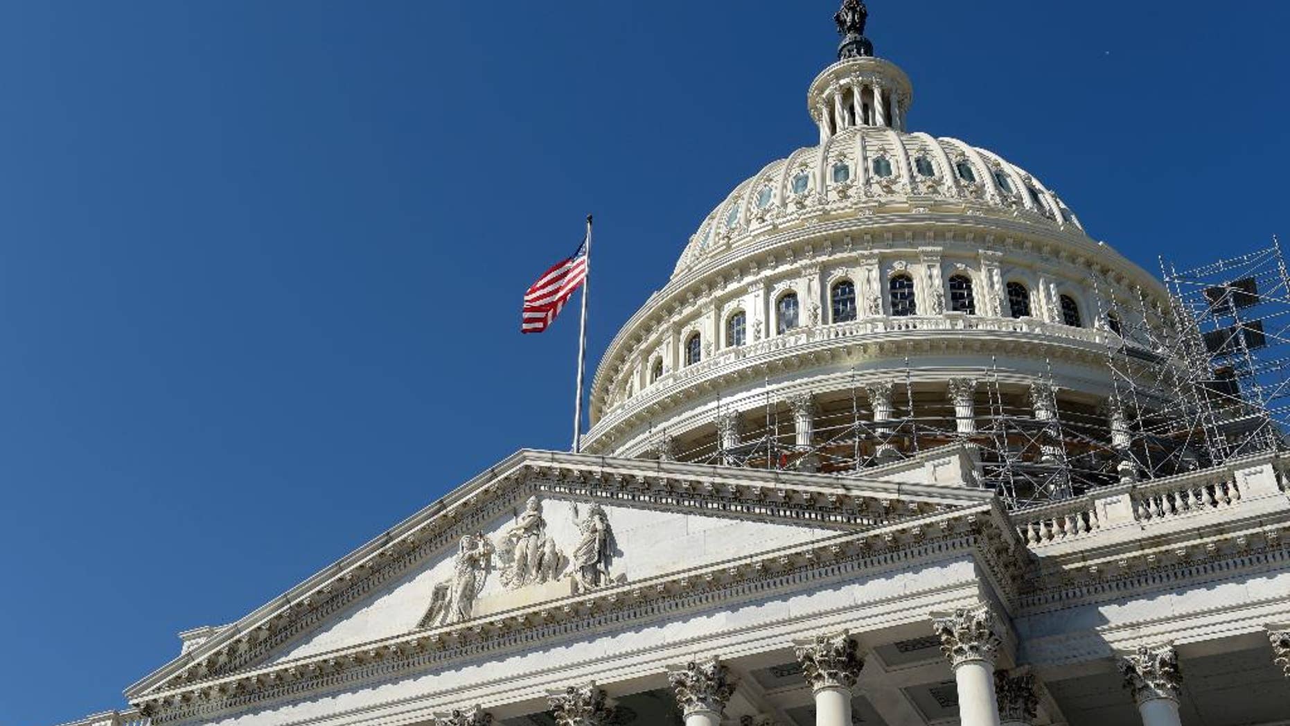 FILE - In this Tuesday, Sept. 6, 2016, file photo, an American flag flies over Capitol Hill in Washington. A group of six Gulf Arab countries expressed "deep concern" Monday over a bill passed by the U.S. Congress that would allow families of Sept. 11 victims to sue the government of Saudi Arabia over the attacks. (AP Photo/Susan Walsh, File)