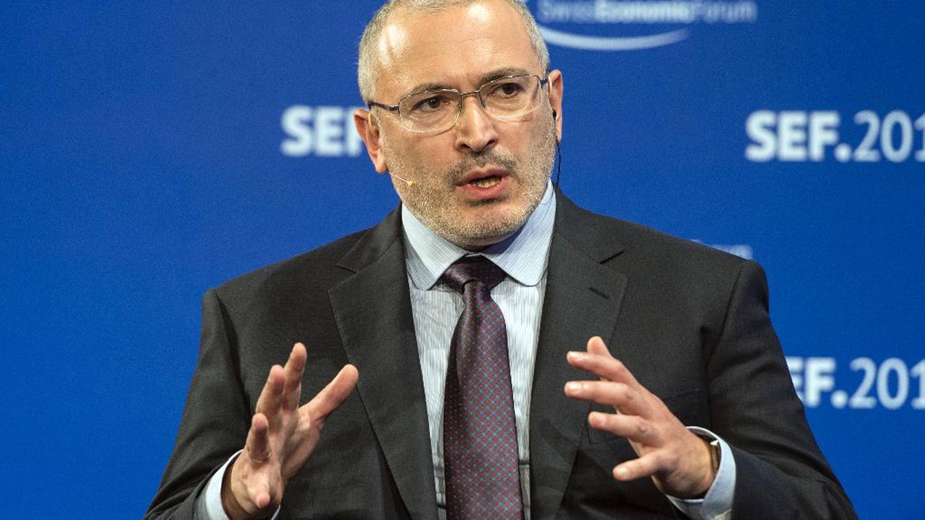 FILE - This is a Thursday, June 4, 2015 file photo of former Russian owner of oil company Yukos, Mikhail Khodorkovsky as he speaks during the Swiss Economic Forum, SEF, in Interlaken, Switzerland. A Dutch court on Wednesday quashed a $50 billion award Russia had been ordered to pay the former majority shareholders of Yukos, a major victory for Moscow in the high-stakes dispute over the dismantling of what was once Russia's largest oil producer. The Hague District Court’s written ruling overturned a July 2014 decision by the Permanent Court of Arbitration, which said that Moscow used massive tax claims to seize control of Yukos in 2003 and silence its CEO, Mikhail Khodorkovsky. (Peter Schneider/Keystone via AP, File)