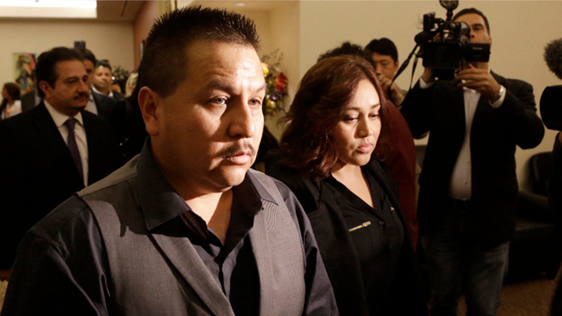 File - This Nov. 4, 2013 file photo shows Rodrigo Lopez, left, and Sujay Cruz, parents of Andy Lopez, as they walk to a news conference in San Francisco. Prosecutors said Monday, July 7, 2014, that they will not file criminal charges against a Northern California sheriff's deputy who shot and killed Andy Lopez, an unarmed 13-year-old boy, whose death last year sparked protests and criticism that the officer acted too quickly. (AP Photo/Jeff Chiu, file)