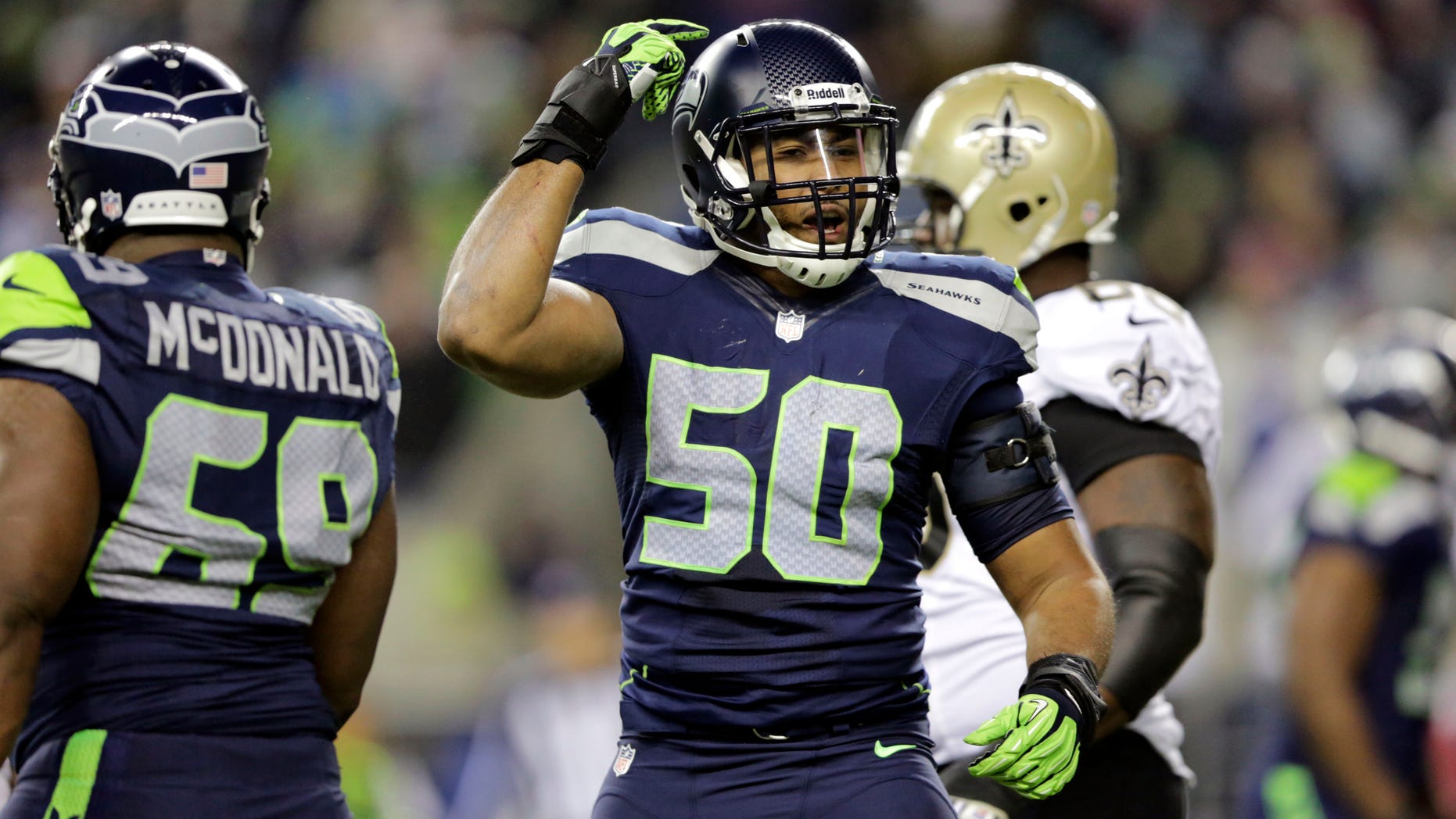 Seattle Seahawks K.J. Wright (50) gestures after a play against the New Orleans Saints in the second half of an NFL football game, Monday, Dec. 2, 2013, in Seattle. (AP Photo/Scott Eklund)