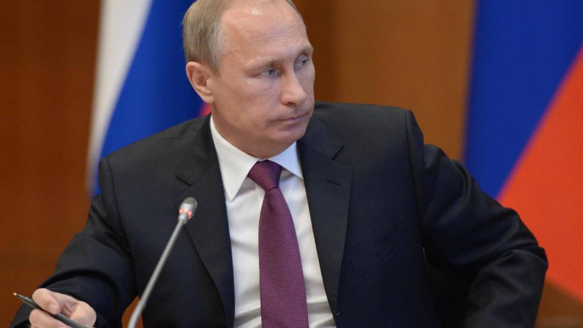 Russian President Vladimir Putin listens during a meeting on development of the Russian Far East issues in Yakutsk, Russia, Monday, Sept. 1, 2014. Russian President Vladimir Putin on Sunday called on Ukraine to immediately start talks on a political solution to the crisis in eastern Ukraine. (AP Photo/RIA Novosti, Alexei Nikolsky, Presidential Press Service)