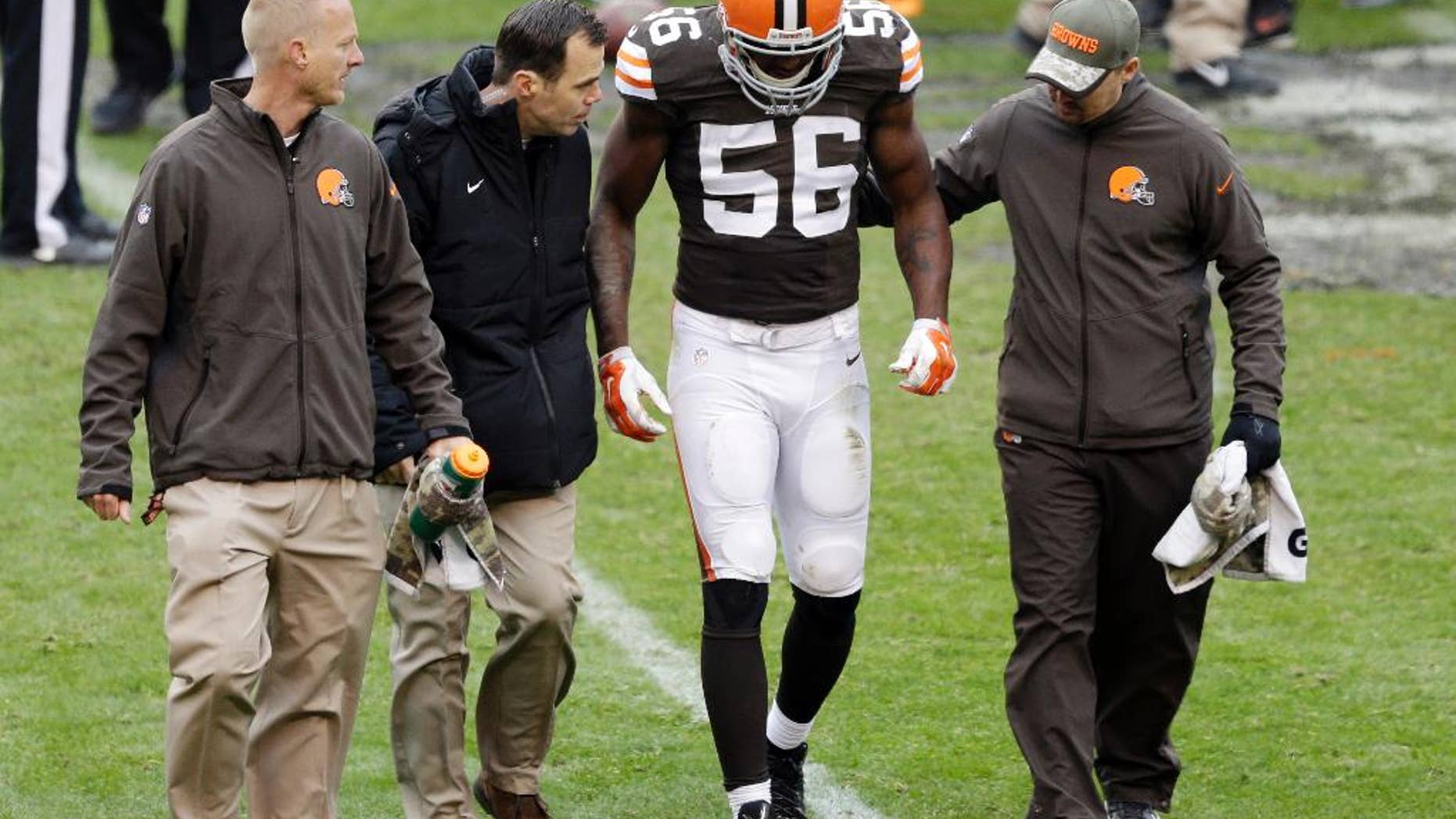 Cleveland Browns inside linebacker Karlos Dansby (56) is helped off the field after an injury in the second quarter of an NFL football game against the Houston Texans, Sunday, Nov. 16, 2014, in Cleveland. (AP Photo/Tony Dejak)