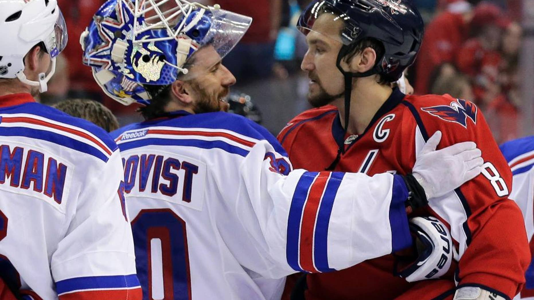 FILE - In this May 13, 2013, file photo, New York Rangers goalie Henrik Lundqvist (30), from Sweden, greets Washington Capitals left wing Alex Ovechkin (8), from Russia, after the Rangers won 5-0 in Game 7 in the first round of the NHL hockey Stanley Cup playoffs. While Ovechkin has guaranteed a win for the Capitals, the Rangers are a team that has beaten Washington twice, in the past three season in Game 7 playoff games. The clubs play Wednesday, May 13, in New York.(AP Photo/Alex Brandon, File)