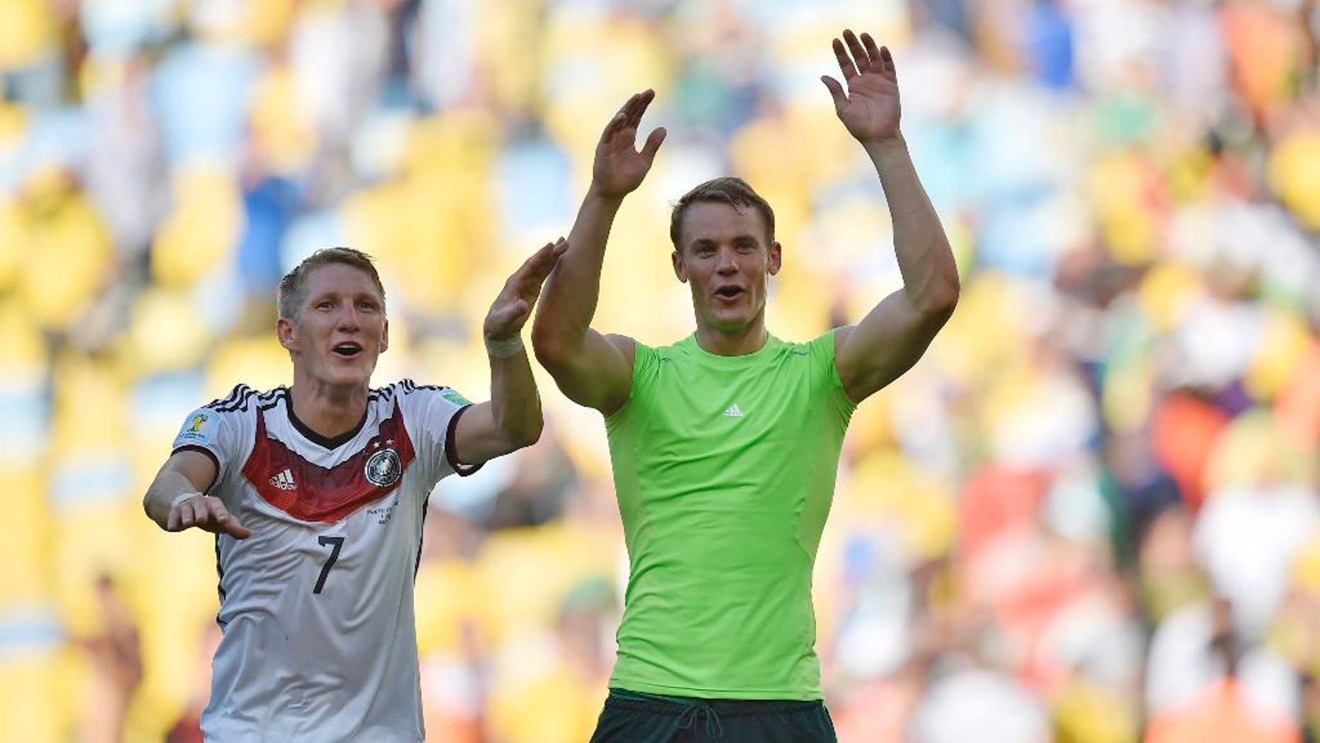 Germany's Bastian Schweinsteiger, left, and goalkeeper Manuel Neuer celebrate at the end of the World Cup quarterfinal soccer match between Germany and France at the Maracana Stadium in Rio de Janeiro, Brazil, Friday, July 4, 2014. Germany won the match 1-0. (AP Photo/Martin Meissner)