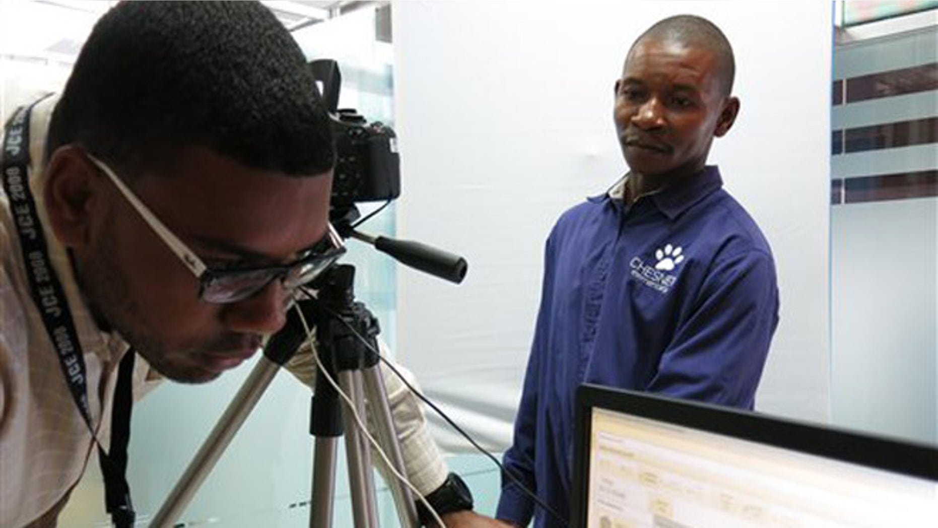 In this June 10, 2014, photo, a Dominican employee takes Haitian Luccene Philome's fingersprints to start his registration in the "regularization process" of foreigners living in the Dominican Republic, in Santo Domingo, Dominican Republic. Thousands of Haitians have been lining up, trying to take advantage of a rare opportunity to secure their legal status, but their hope is quickly dissipating because of the lack of their Haitians ID's. (AP Photo/Ezequiel Abiu Lopez)