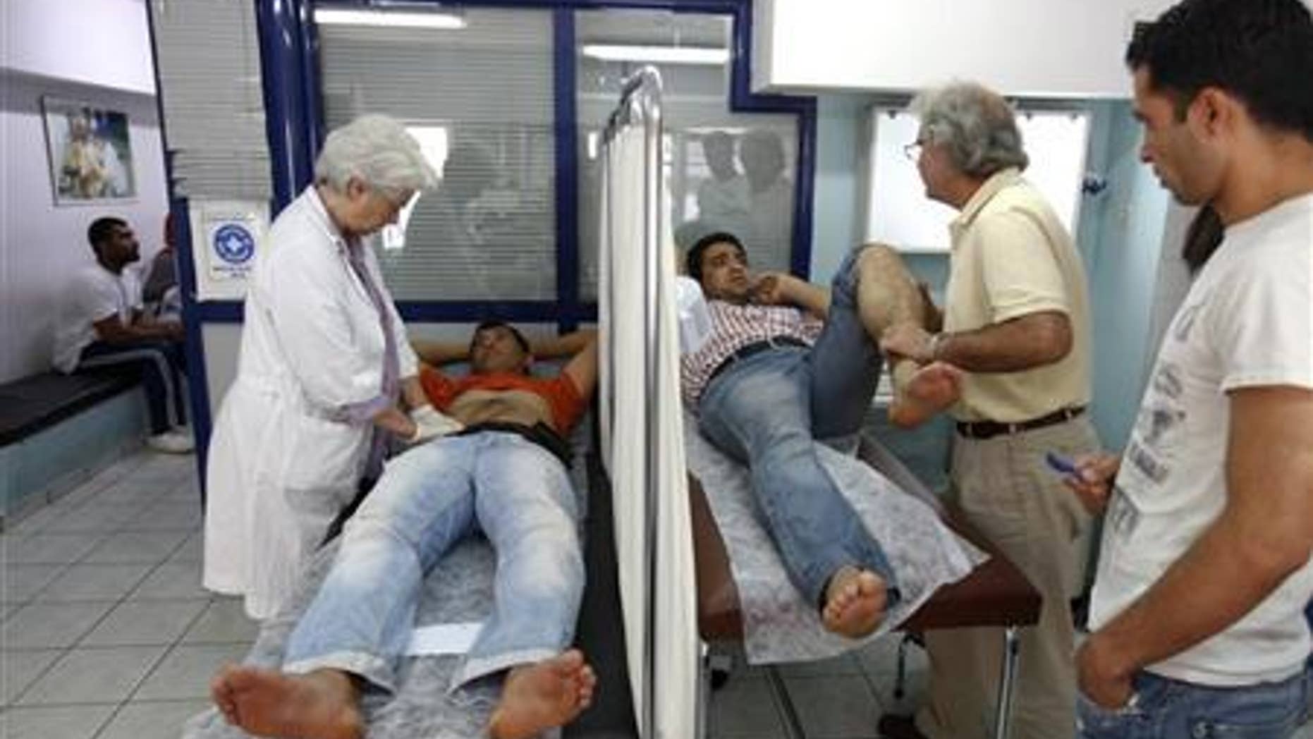 Doctors examine patients at a medical center of the Greek delegation of the Doctors of the World in Athens.