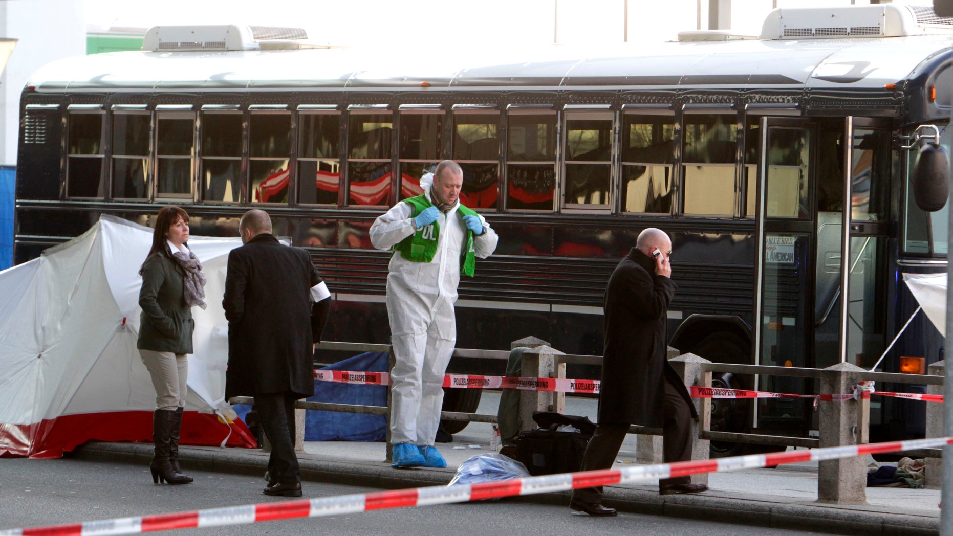 March 2, 2011 file photo police investigate the scene after a gunman fired shots at U.S. soldiers on the bus outside Frankfurt airport, Germany. A 21-year-old Kosovo Albanian charged with the fatal shooting of two U.S. airmen outside Frankfurt airport will go on trial, Wednesday, Aug. 31, 2011.