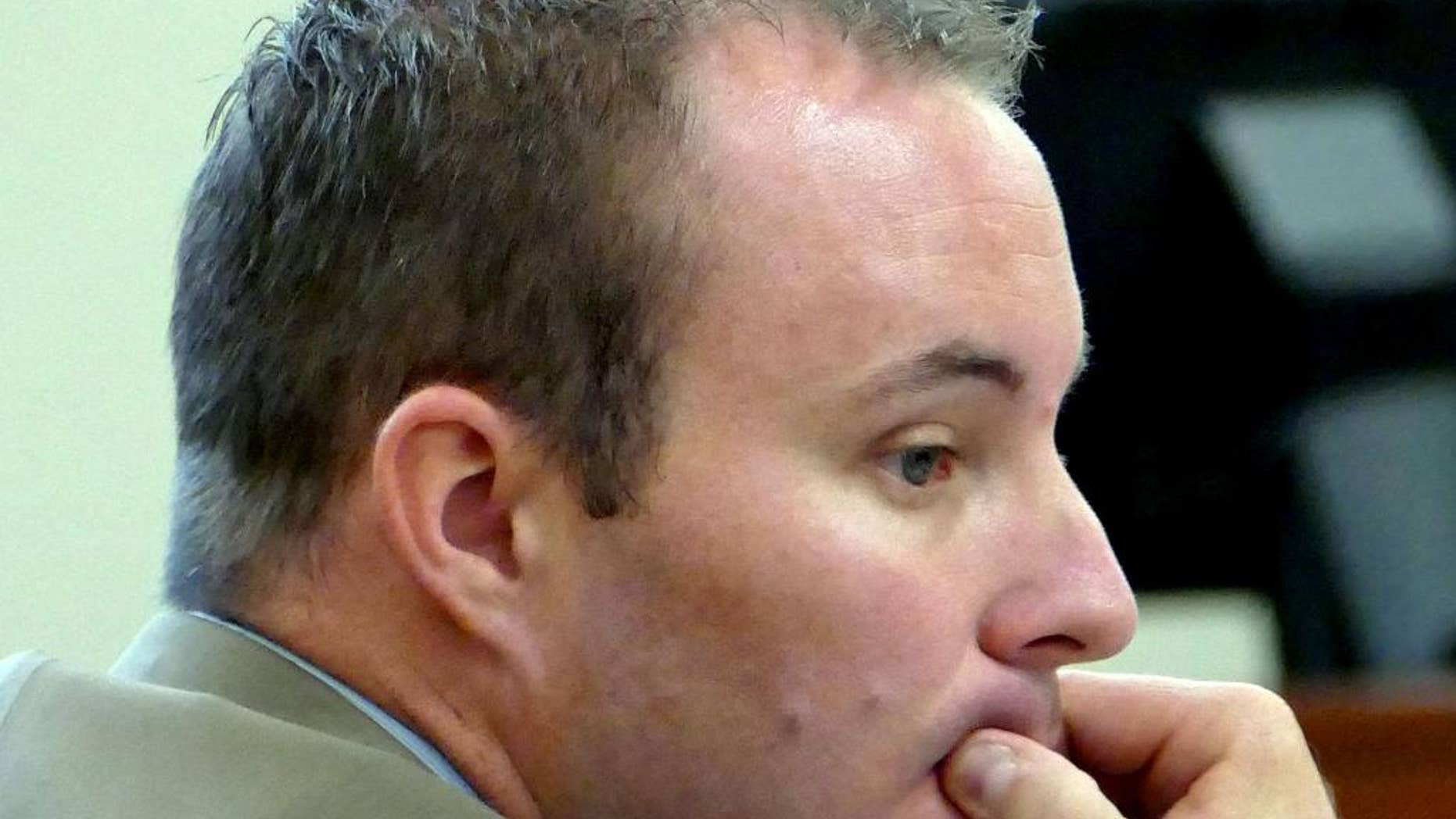 FILE - In this Aug. 17, 2015, file photo, Charlotte-Mecklenburg police Officer Randall "Wes" Kerrick sits at the defense table during his manslaughter trial in Charlotte, N.C. State attorneys on Friday, Aug. 28, 2015, decided against retrying Kerrick, who shot and killed an unarmed black man after his trial ended in a deadlock last week. (Davie Hinshaw/The Charlotte Observer via AP, Pool, File)
