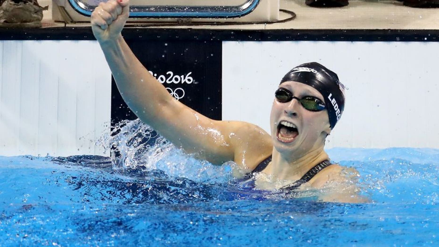 RIO DE JANEIRO, BRAZIL - AUGUST 07: Katie Ledecky of the United States celebrates winning gold and setting a new world record in the Women's 400m Freestyle Final on Day 2 of the Rio 2016 Olympic Games at the Olympic Aquatics Stadium on August 7, 2016 in Rio de Janeiro, Brazil. (Photo by Ryan Pierse/Getty Images)