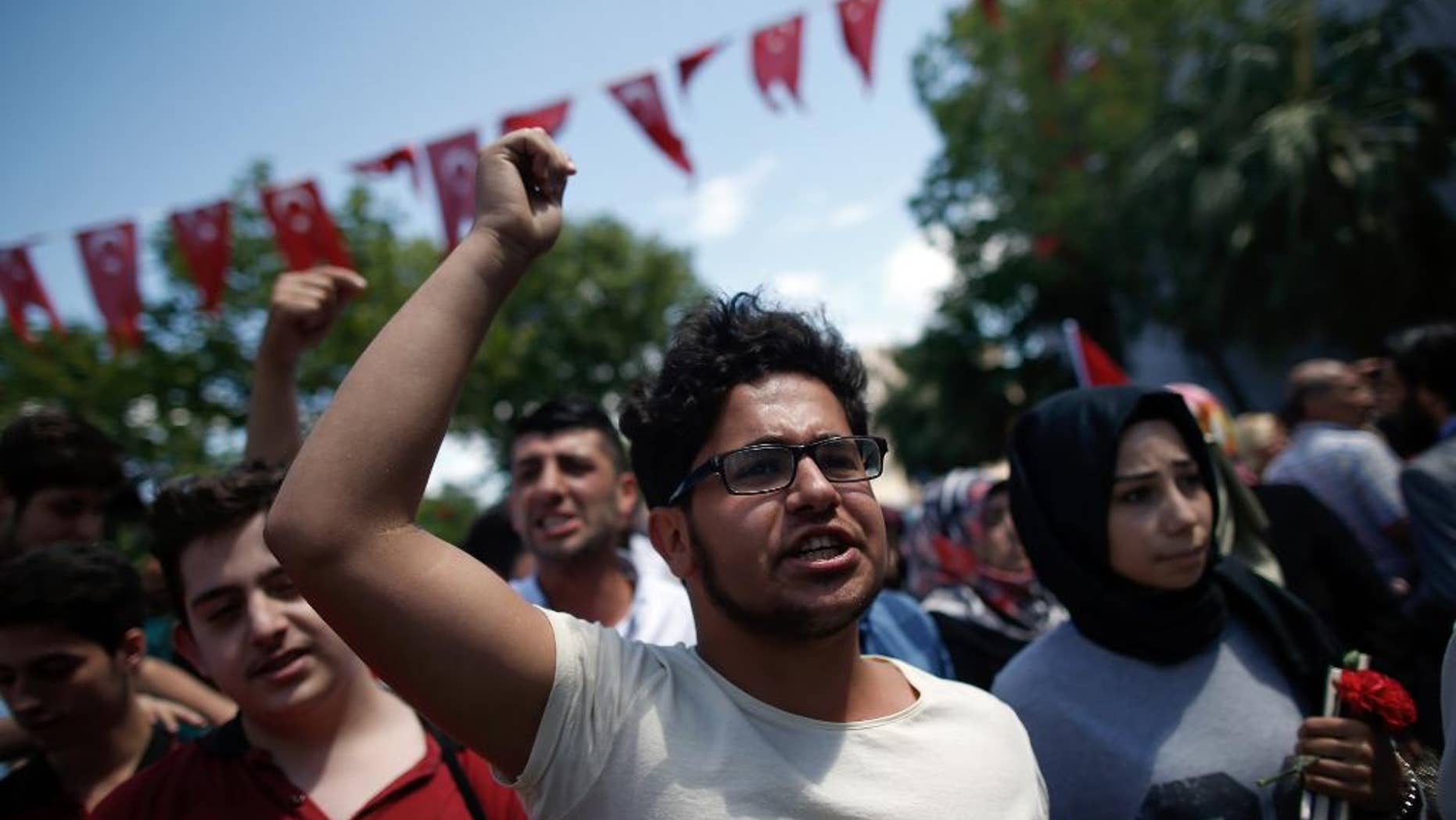 June 8, 2016: People shout to condemn terrorism as they visit the site of Tuesday explosion in Istanbul.