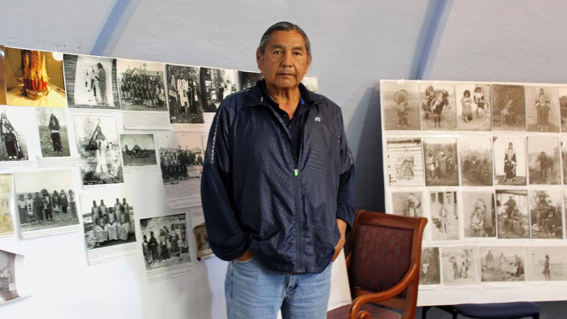 In this May 6, 2016, file photo, Russell Eagle Bear, the historic preservation officer for the Rosebud Sioux Tribe, stands in his office in in Rosebud, S.D. A group of tribes pushing to place Pe' Sla, a site that's sacred to the Great Sioux Nation, into a federal trust has come up against the state of South Dakota. The state in April appealed a federal decision to take the land purchased by the tribes into trust. (AP Photo/Regina Garcia Cano, File)