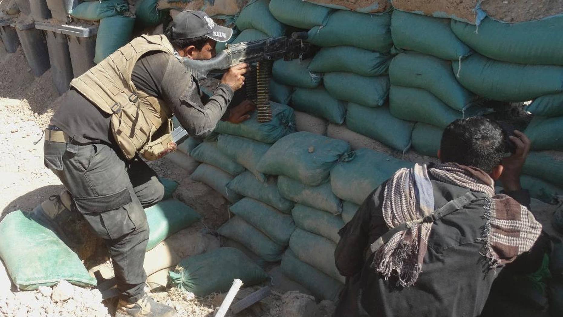 Members of Anti-terrorism forces take up combat positions after regaining control of Znkurh area, Ramadi, Iraq. Iraqi security forces, backed by Sunni and Shiite volunteers supported by U.S.-led coalition airstrikes against Islamic State group advanced their position after clashes in the western suburbs of Ramadi, Anbar province, Iraq, Thursday, Oct. 8, 2015. (AP Photo)