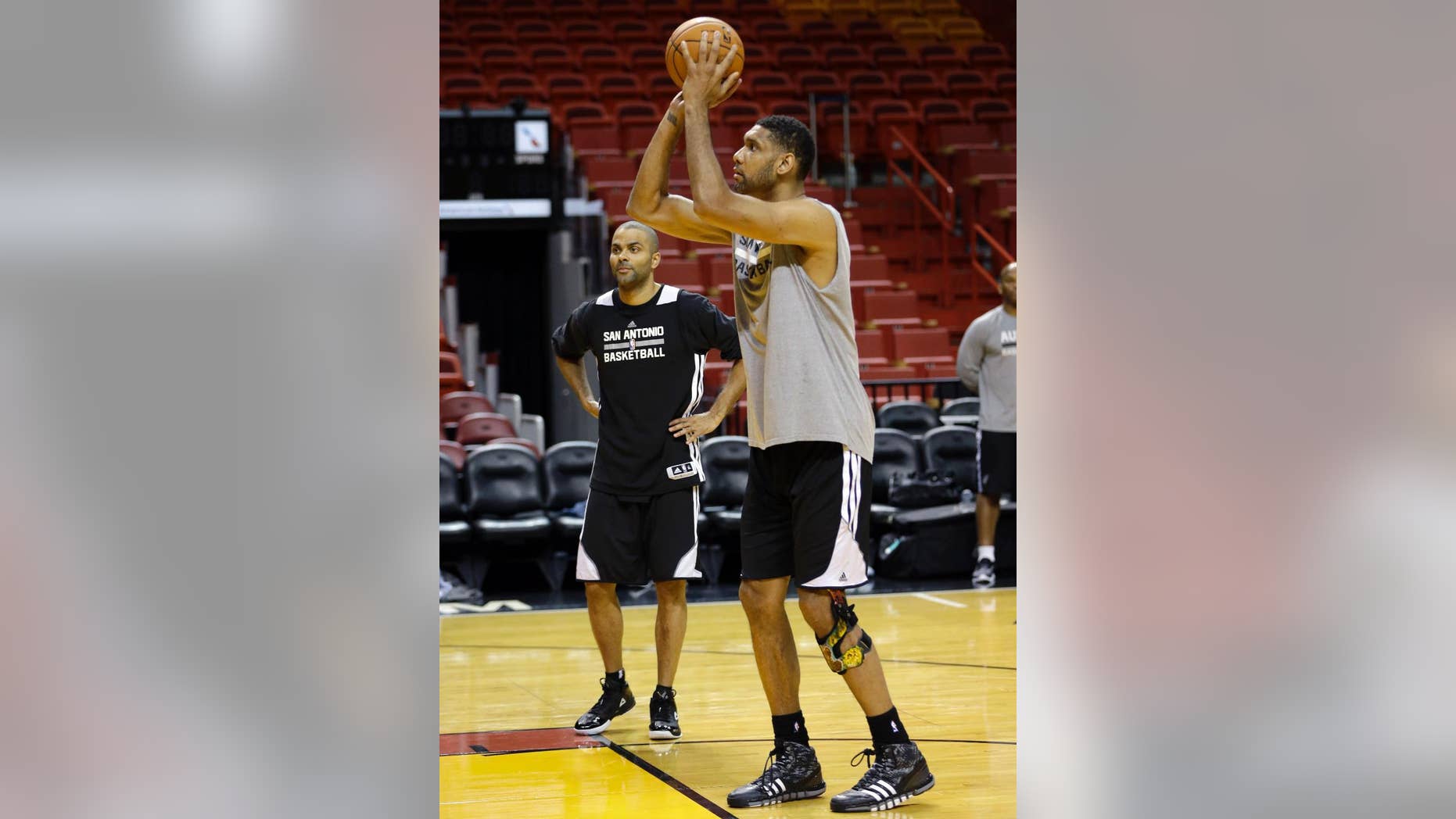 San Antonio Spurs' Tim Duncan, right, shoots as Tony Parker, left, looks on during basketball practice at the NBA Finals, Wednesday, June 11, 2014, in Miami. The Spurs lead the Miami Heat 2-1 in the best-of-seven games series. (AP Photo/Lynne Sladky)