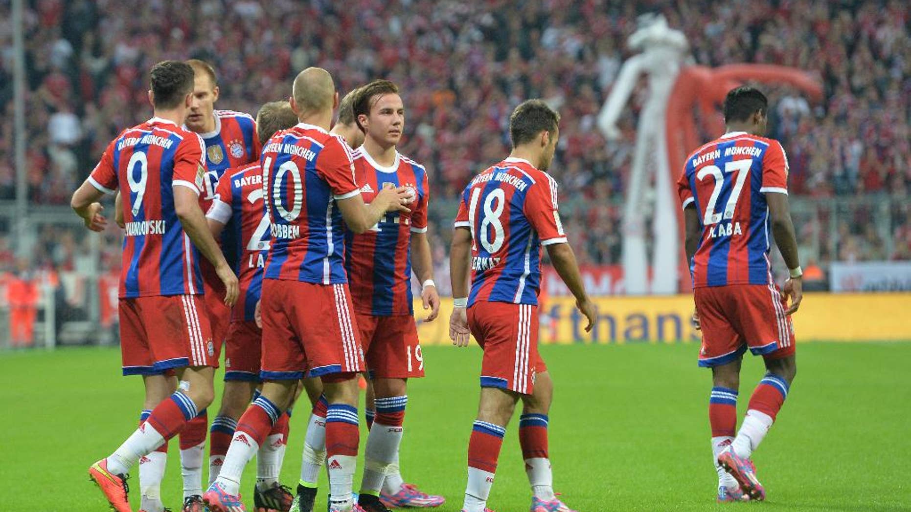 Bayern's players celebrate after scoring during the soccer match between FC Bayern Munich and VfL Wolfsburg in the Allianz Arena in Munich, Germany, on Friday, Aug. 22, 2014. (AP Photo/Kerstin Joensson)