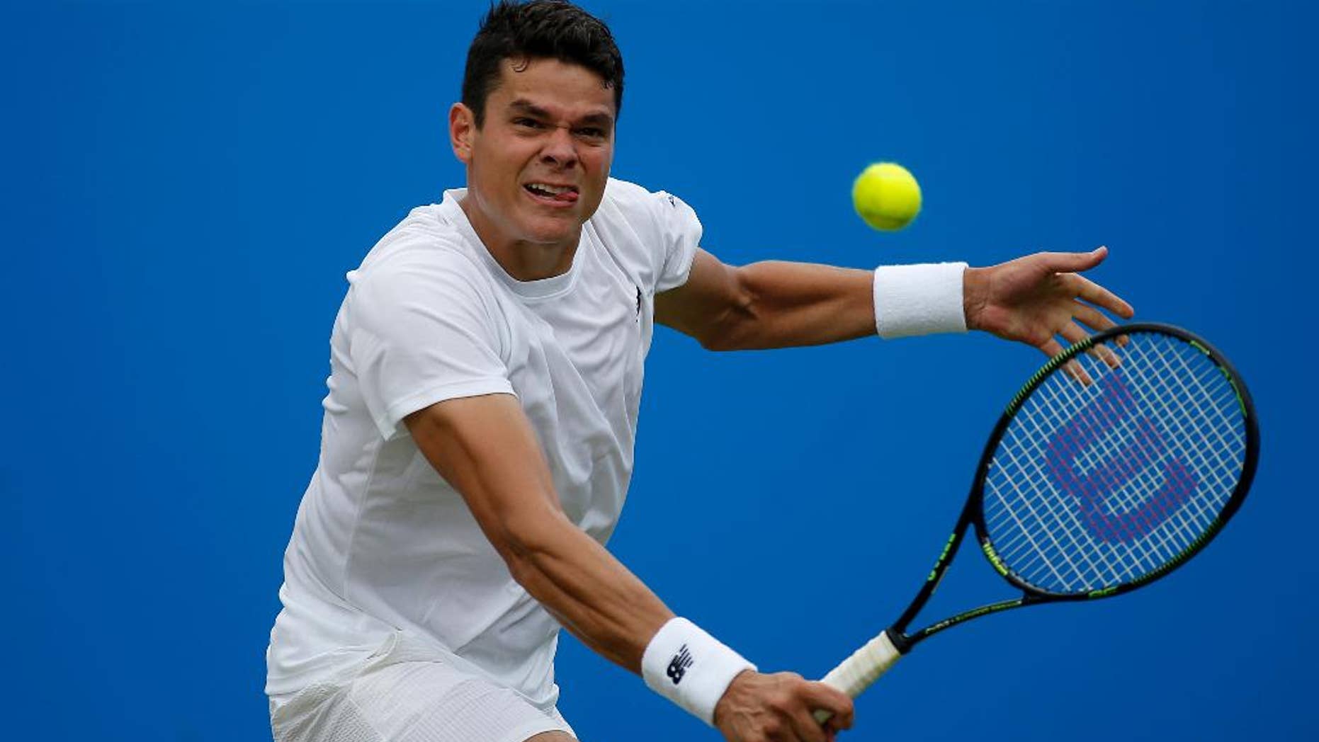 Canada's Milos Raonic makes a return to the Czech Republic's Jiri Vesely, during day four of the 2016 tennis Championships at The Queen's Club, London, Thursday June 16, 2016. (Steve Paston/PA via AP) UNITED KINGDOM OUT