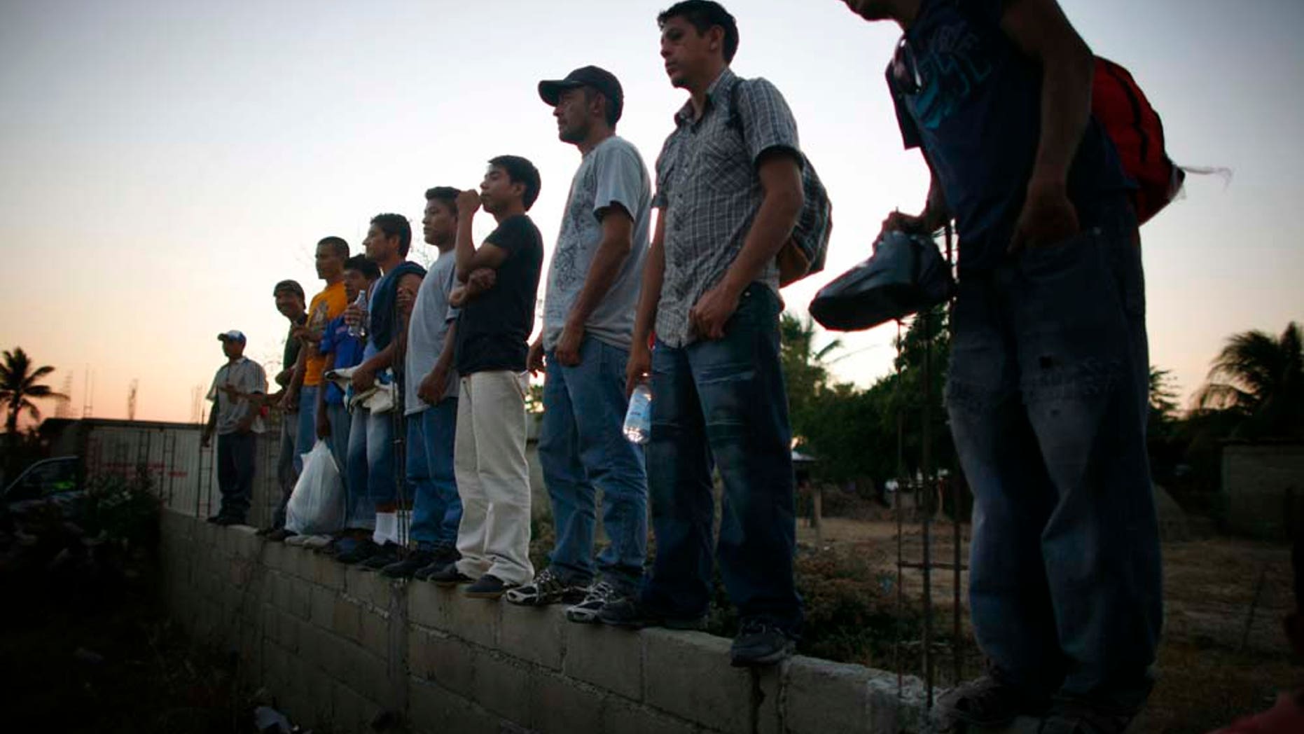 Migrantes centroamericanos esperan de pie afuera de la Casa del Migrante en Arriaga, Chiapas, el viernes 7 de enero del 2011. El tren más usado por los migrantes en su camino de este estado del sur de México hacia Estados Unidos no llegó el viernes a Arriaga y las autoridades locales hicieron un operativo sorpresa para escoltar a los migrantes a la frontera con el estado de Oaxaca. De acuerdo con varias organizaciones defensoras de los derechos de los migrantes, las autoridades detuvieron el tren en Oaxaca para sabotear una protesta programada para el viernes a bordo del tren. (Foto AP/Miguel Tovar)