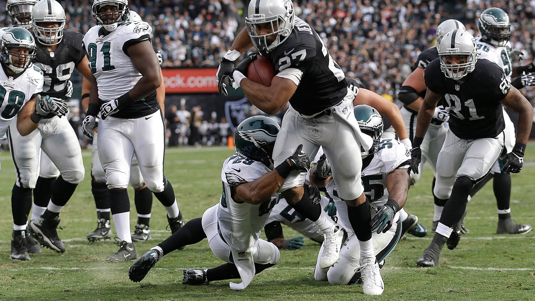 Oakland Raiders running back Rashad Jennings (27) runs for an 8-yard touchdown against the Philadelphia Eagles during the second quarter of an NFL football game in Oakland, Calif., Sunday, Nov. 3, 2013. (AP Photo/Marcio Jose Sanchez)