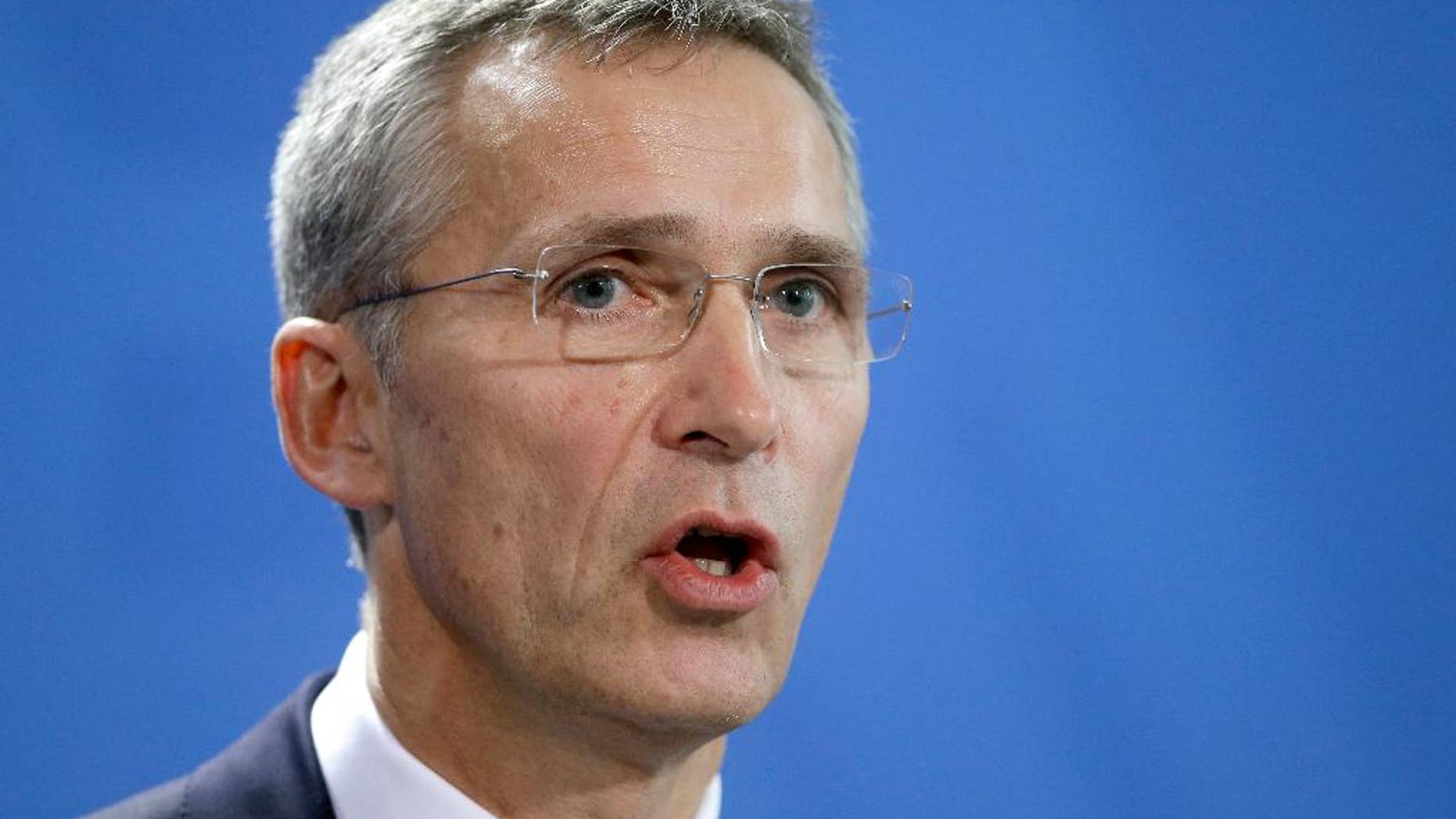 NATO Secretary General Jens Stoltenberg speaks during a joint press conference as part of a meeting with German Chancellor Angela Merkel at the chancellery in Berlin, Germany, Wednesday, Jan. 14, 2015. (AP Photo/Michael Sohn)