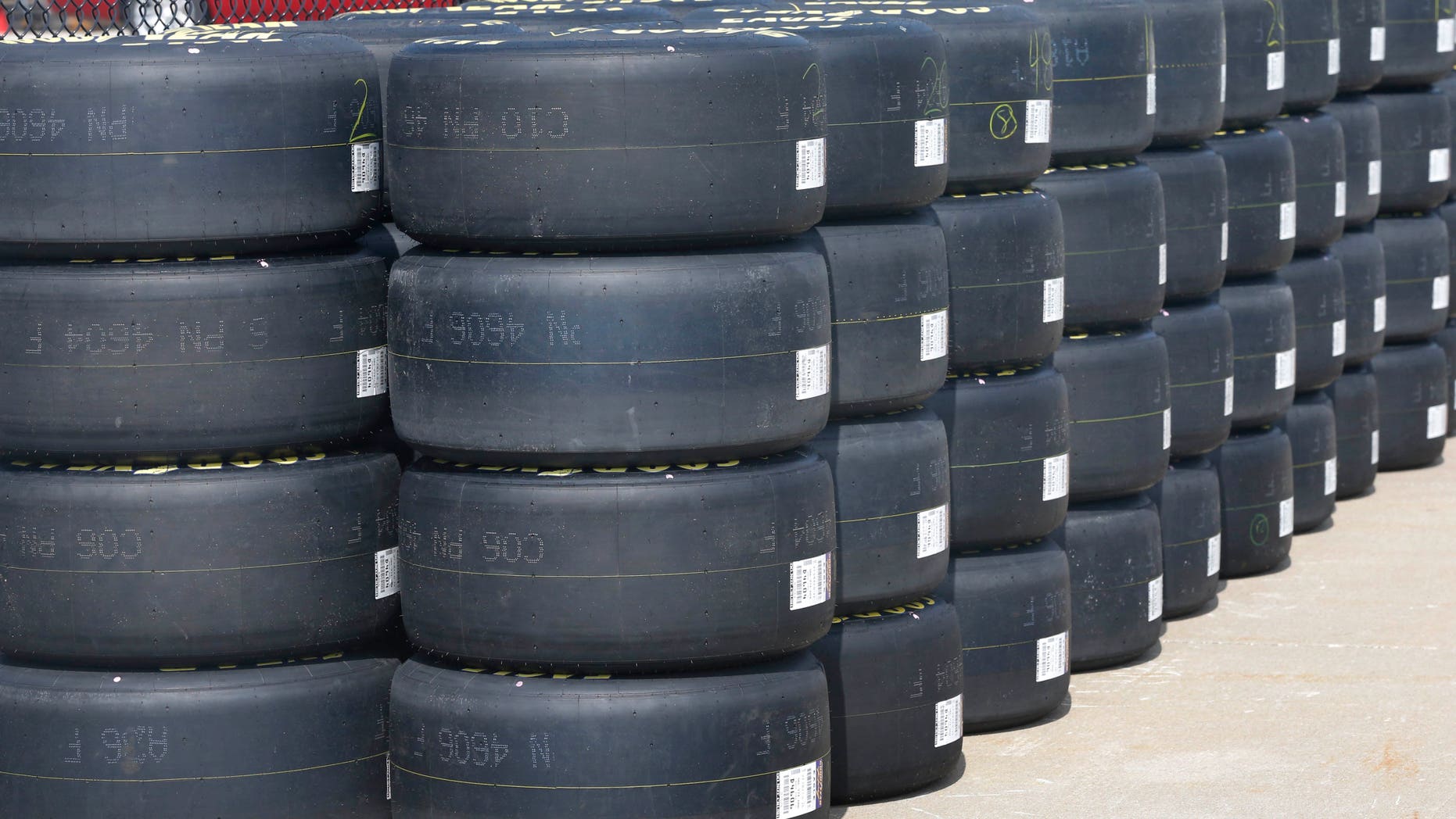 Goodyear racing tires await distribution to NASCAR teams at Kansas Speedway in Kansas City, Kan., Thursday, Oct. 3, 2013. Teams are testing tires on the recently re-surfaced track. (AP Photo/Orlin Wagner)