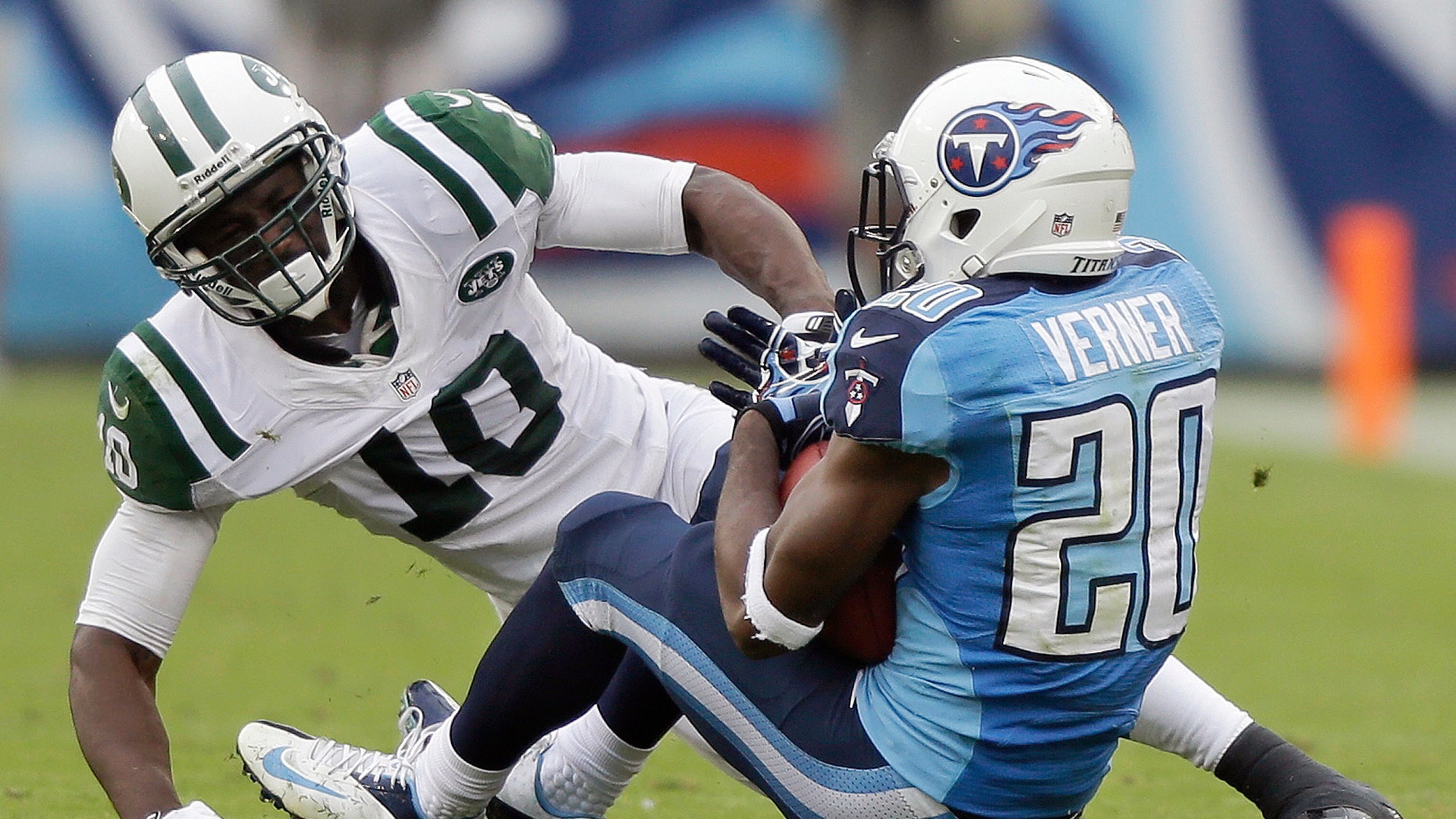 FILE - In this Sept 29, 2013, file photo, Tennessee Titans cornerback Alterraun Verner (20) intercepts a pass intended for New York Jets wide receiver Santonio Holmes (10) during the second quarter of an NFL football game in Nashville, Tenn. The Kansas City Chiefs and the Titans are tied for the most takeaways in the NFL. Well, actually Titans safety Michael Griffin says it's mostly cornerback Alterraun Verner, who leads the league with six takeaways all by himself. (AP Photo/Wade Payne, File)