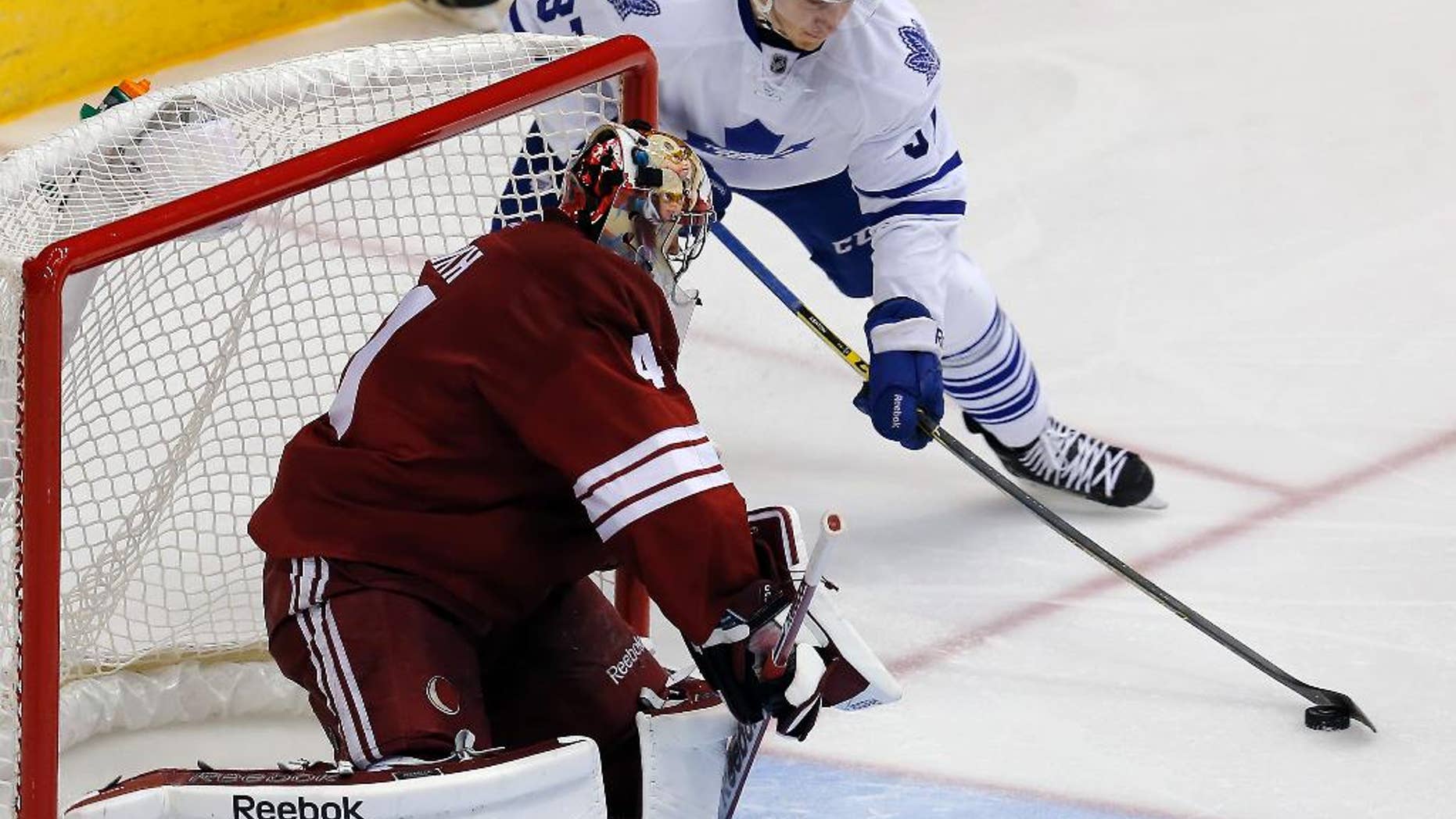 Toronto Maple Leafs right wing Carter Ashton (37) tries to score on Arizona Coyotes goalie Mike Smith during the third period during an NHL hockey game, Tuesday, Nov. 4, 2014, in Glendale, Ariz. Phoenix won 3-2. (AP Photo/Rick Scuteri)