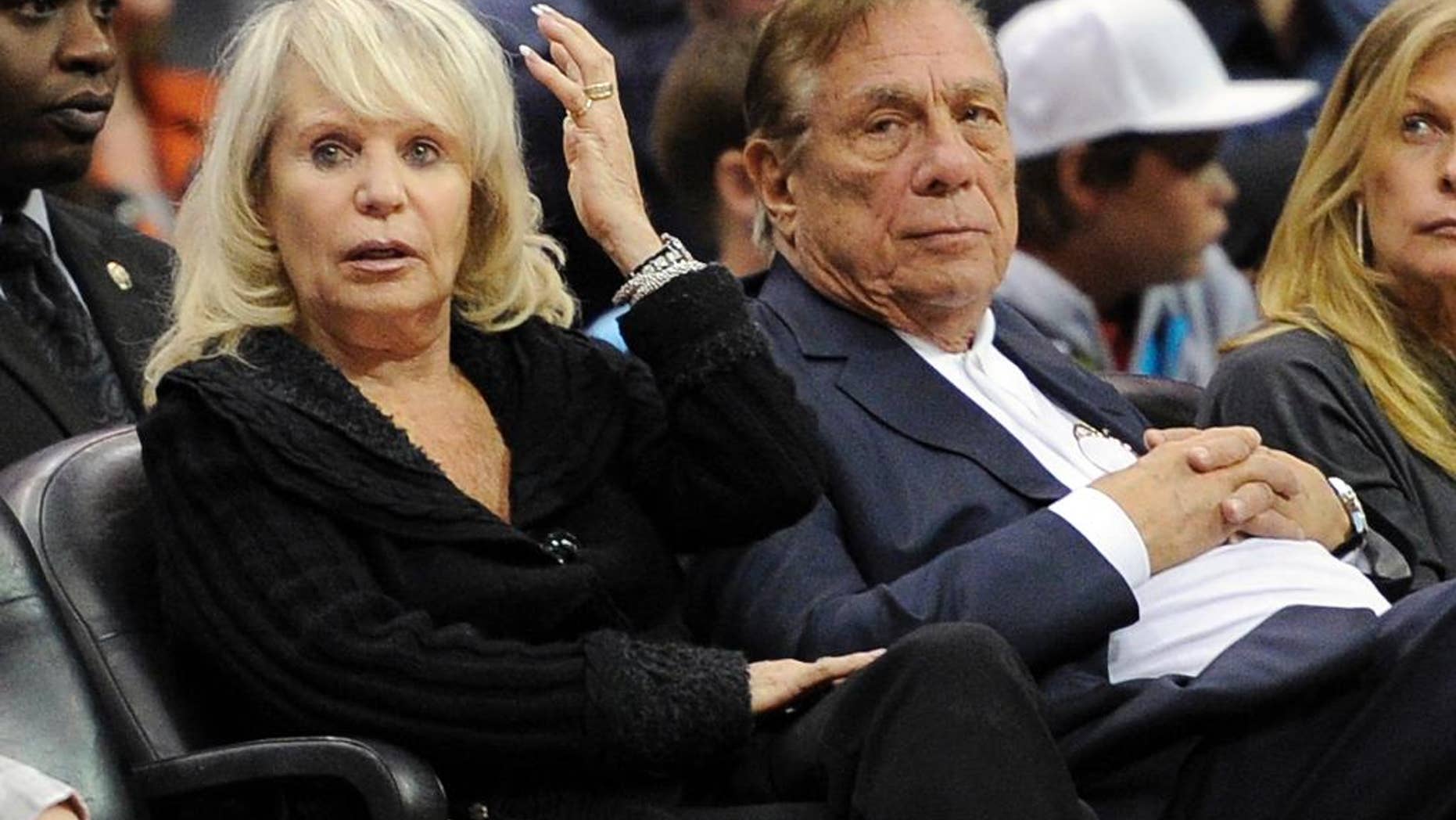 FILE - In this Nov. 12, 2010, file photo, Shelly Sterling sits with her husband, Donald Sterling, right, during the Los Angeles Clippers' NBA basketball game against the Detroit Pistons in Los Angeles. An individual with knowledge of negotiations to sell the Clippers says Shelly Sterling has reached an agreement to sell the team to former Microsoft CEO Steve Ballmer for $2 billion. The individual, who wasn't authorized to speak publicly, told The Associated Press on Thursday, May 29, 2014, that Ballmer and the Sterling Family Trust now have a binding agreement. The deal now must be presented to the NBA. (AP Photo/Mark J. Terrill, File)