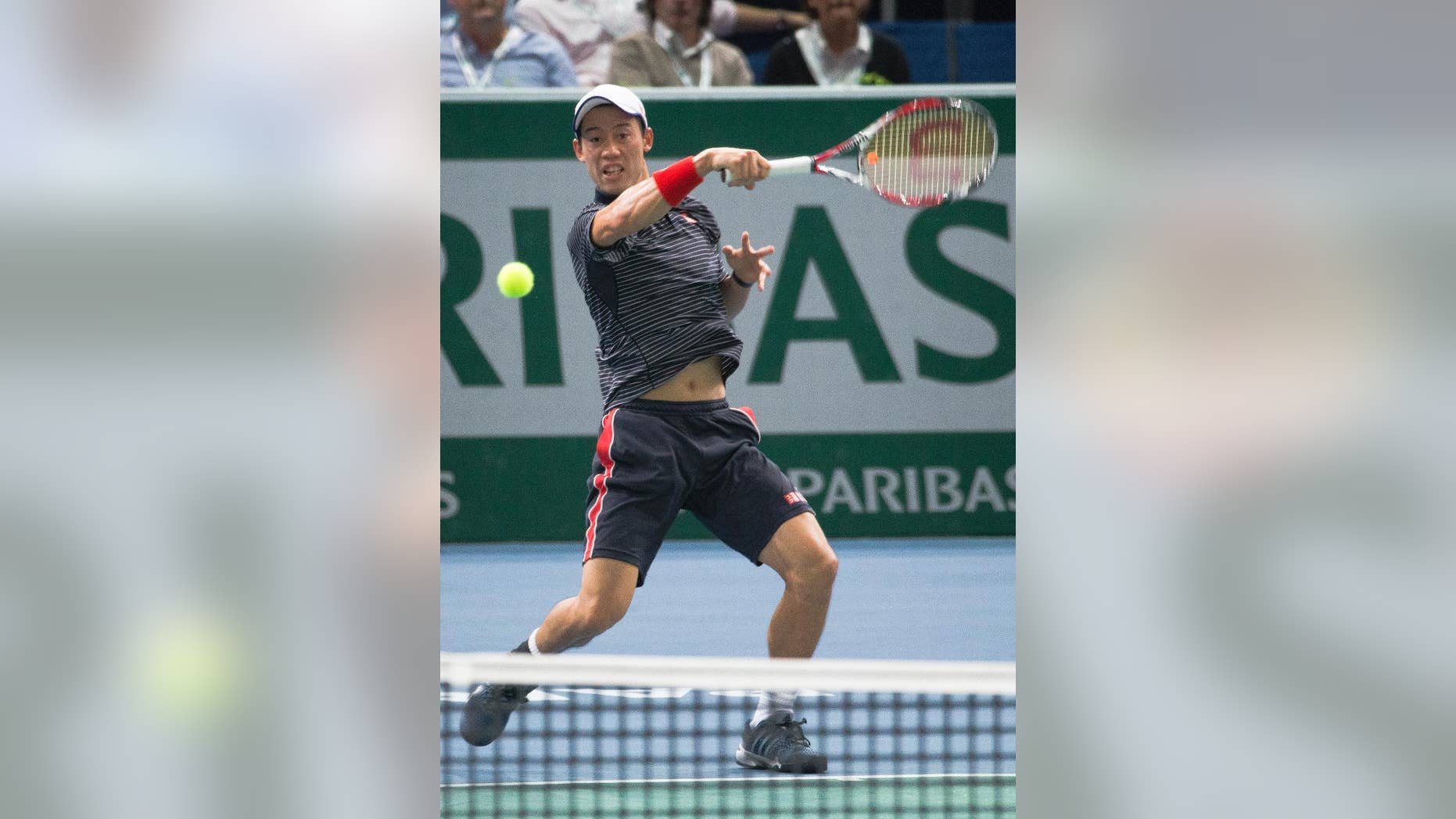 Kei Nishikori of Japan return the ball against France's Jo-Wilfried Tsonga during their third round match at the ATP World Tour Masters tennis tournament at Bercy stadium in Paris, France, Thursday, Oct. 30, 2014. (AP Photo/Jacques Brinon)