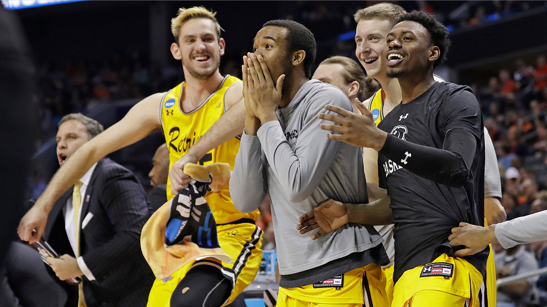 UMBC players celebrate a teammate's basket against Virginia during the second half of a first-round game in the NCAA men's college basketball tournament in Charlotte, N.C., March 16, 2018.