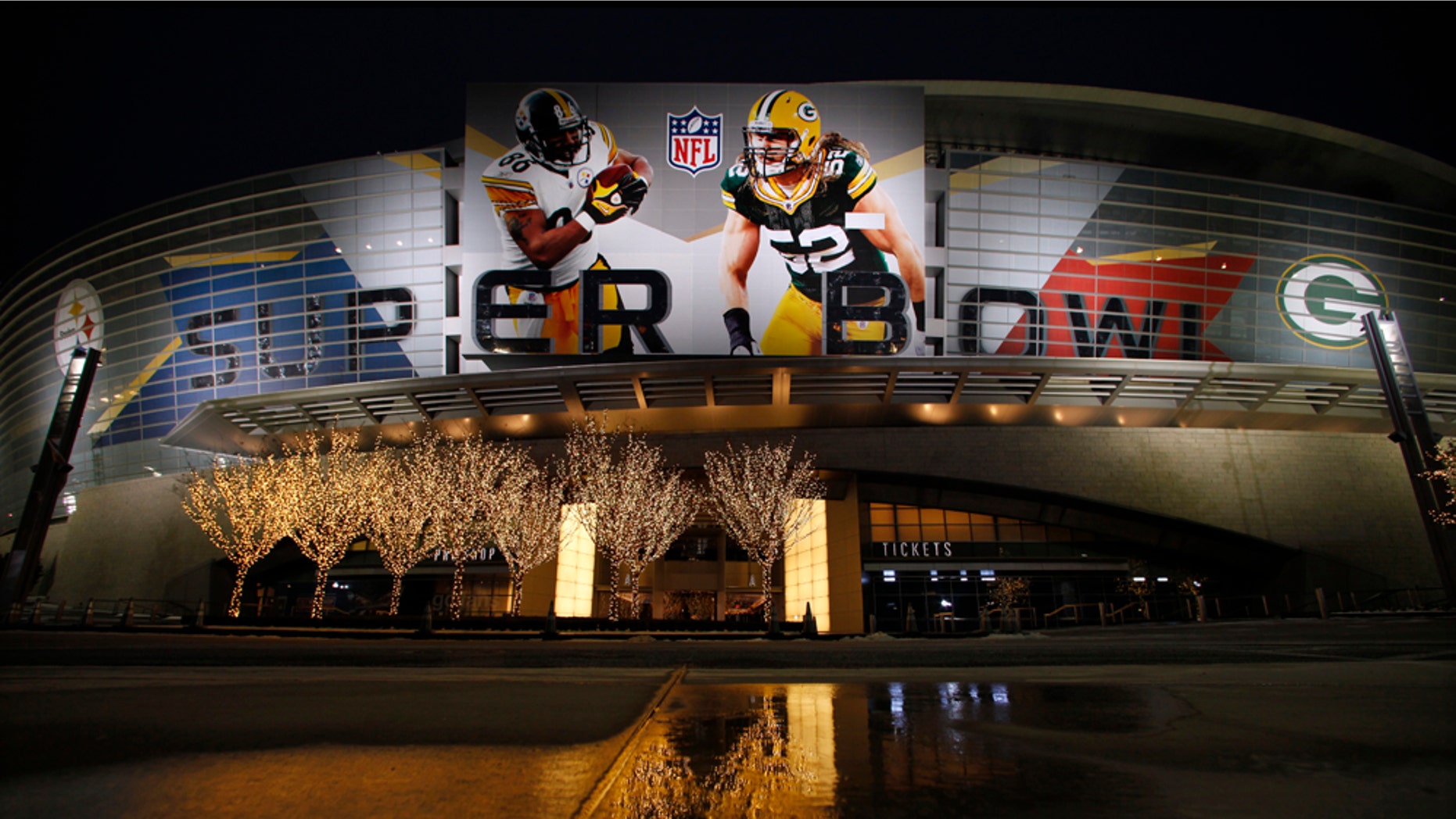 Lights are reflected on an icy pavement outside of Cowboys Stadium where the NFL football Super Bowl XLV will be played between the Green Bay Packers and the Pittsburgh Steelers Thursday, Feb. 3, 2011, in Arlington, Texas. (AP Photo/Charlie Riedel)