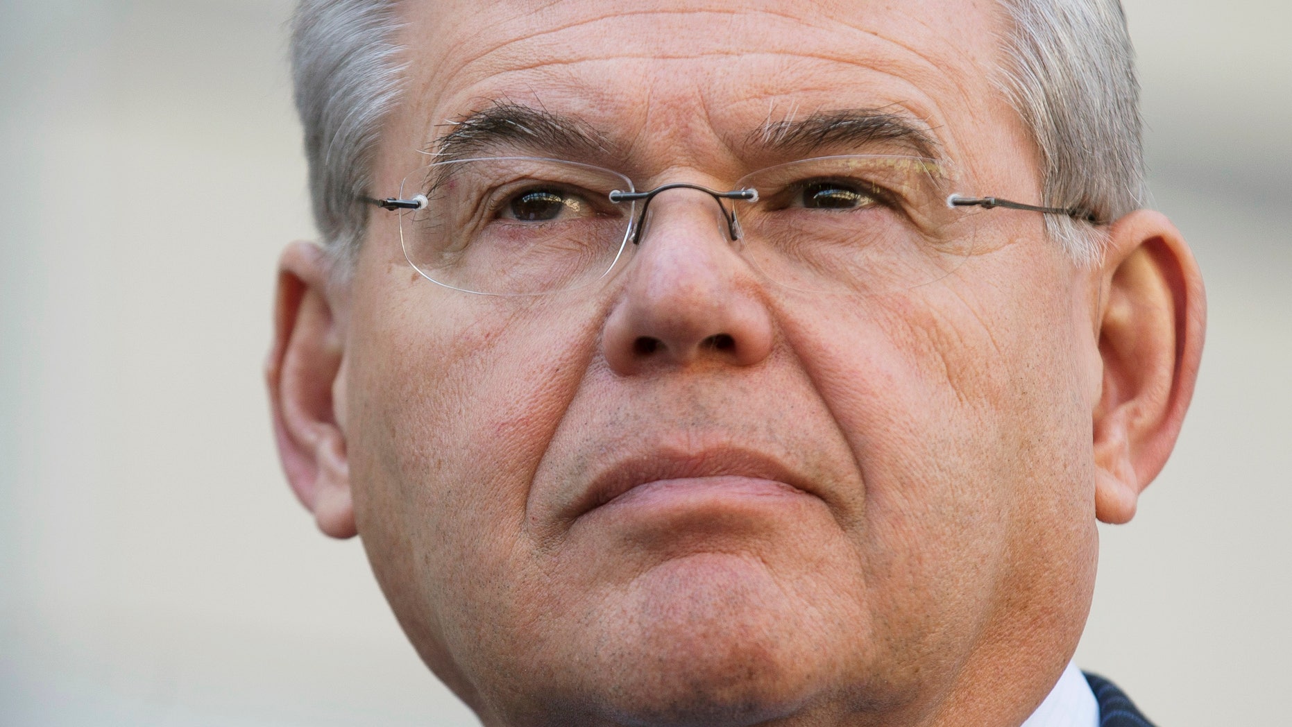 U.S. Sen. Bob Menendez waits to speak outside federal court, Thursday, April 2, 2015, in Newark, N.J.