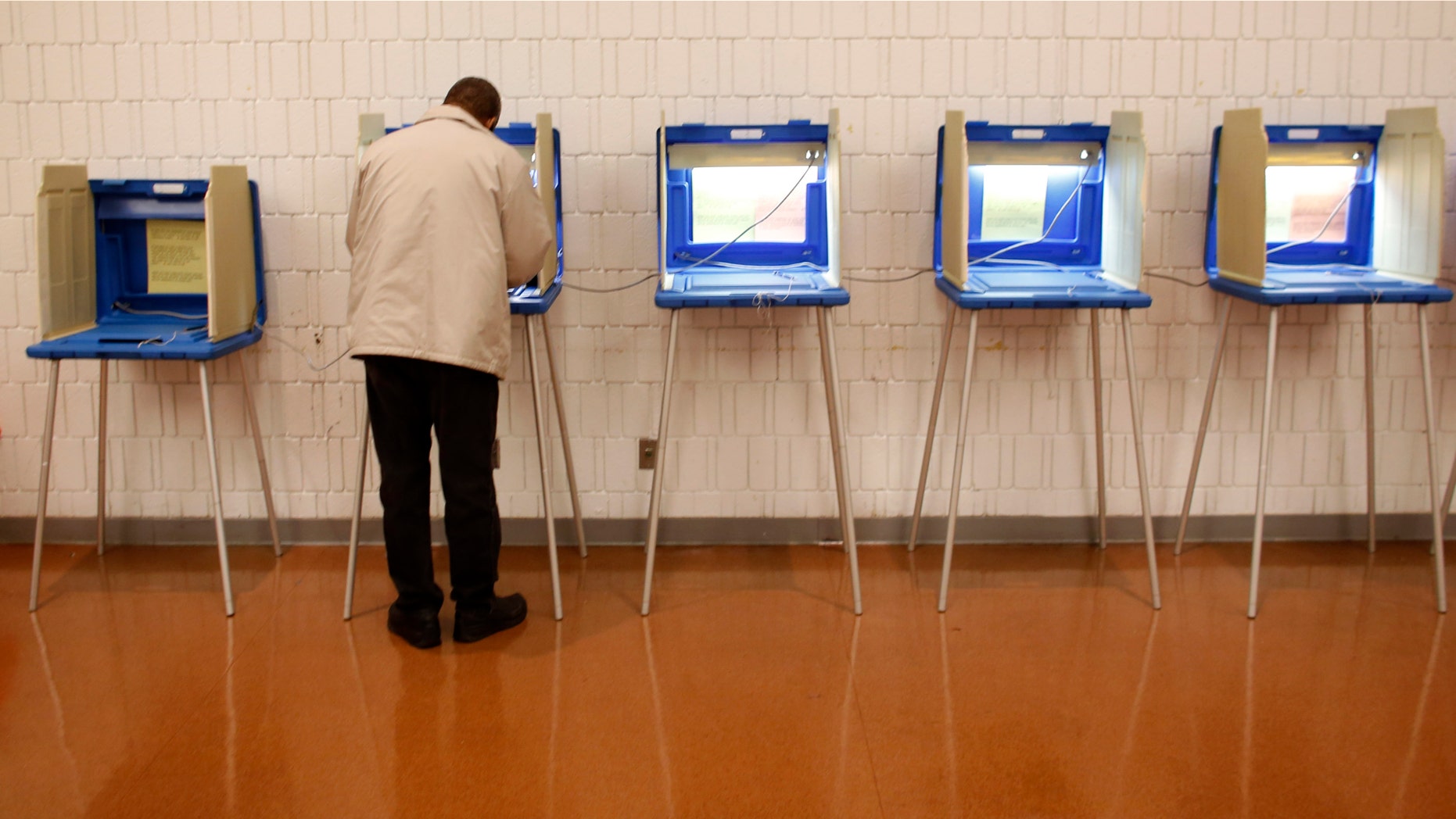 MILWAUKEE, WI - NOVEMBER 06: A man casts' his ballot in the U.S. presidential election on November 6, 2012 in Milwaukee, Wisconsin. As Americans are heading to the ballots, polls show that U.S. President Barack Obama and Republican presidential candidate Mitt Romney are in a tight race. (Photo by Darren Hauck/Getty Images)