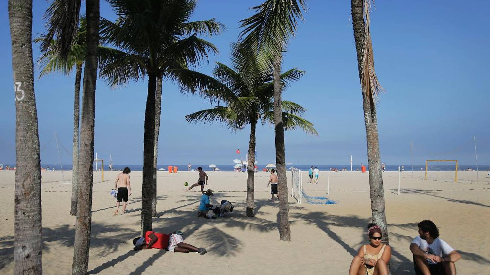 People sleep, play soccer, and relax on the Copacabana beach in Rio de Janeiro, Brazil, Monday, June 16, 2014. Rio de Janeiro is one of the host cities for the 2014 World Cup soccer tournament.(AP Photo/Wong Maye-E)