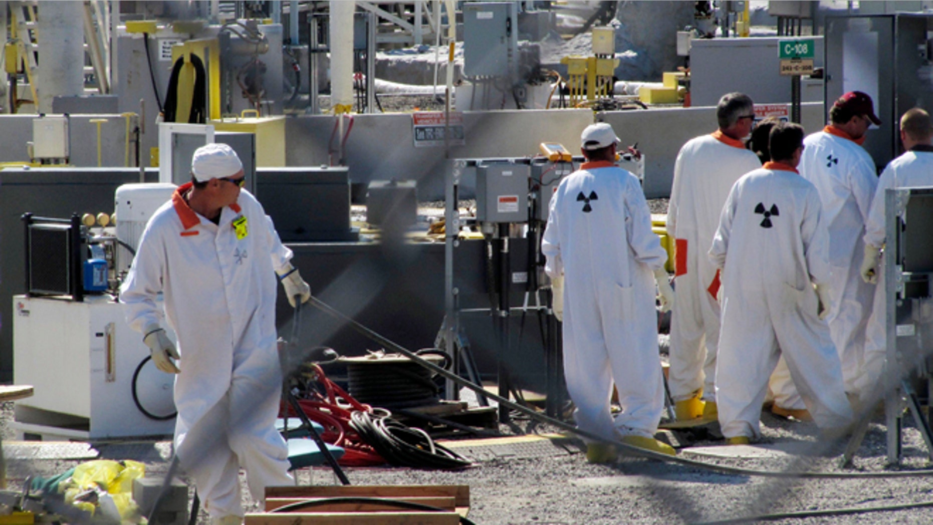July 14, 2010: In this photo, workers at the Hanford nuclear reservation work around a a tank farm where highly radioactive waste is stored underground near Richland, Wash.
