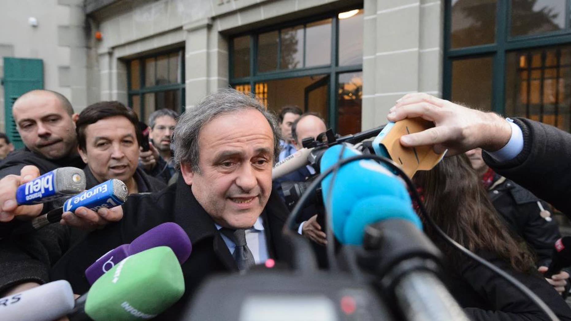 UEFA-President Michel Platini of France is surrounded by media after a hearing at the international Court of Arbitration for Sport, CAS, in Lausanne, Switzerland, Tuesday, Dec. 8, 2015. Platini appealed against a 90-day ban which is keeping him out of the presidential race for the sport's scandal-plagued governing body FIFA. (Laurent Gillieron/Keystone via AP)