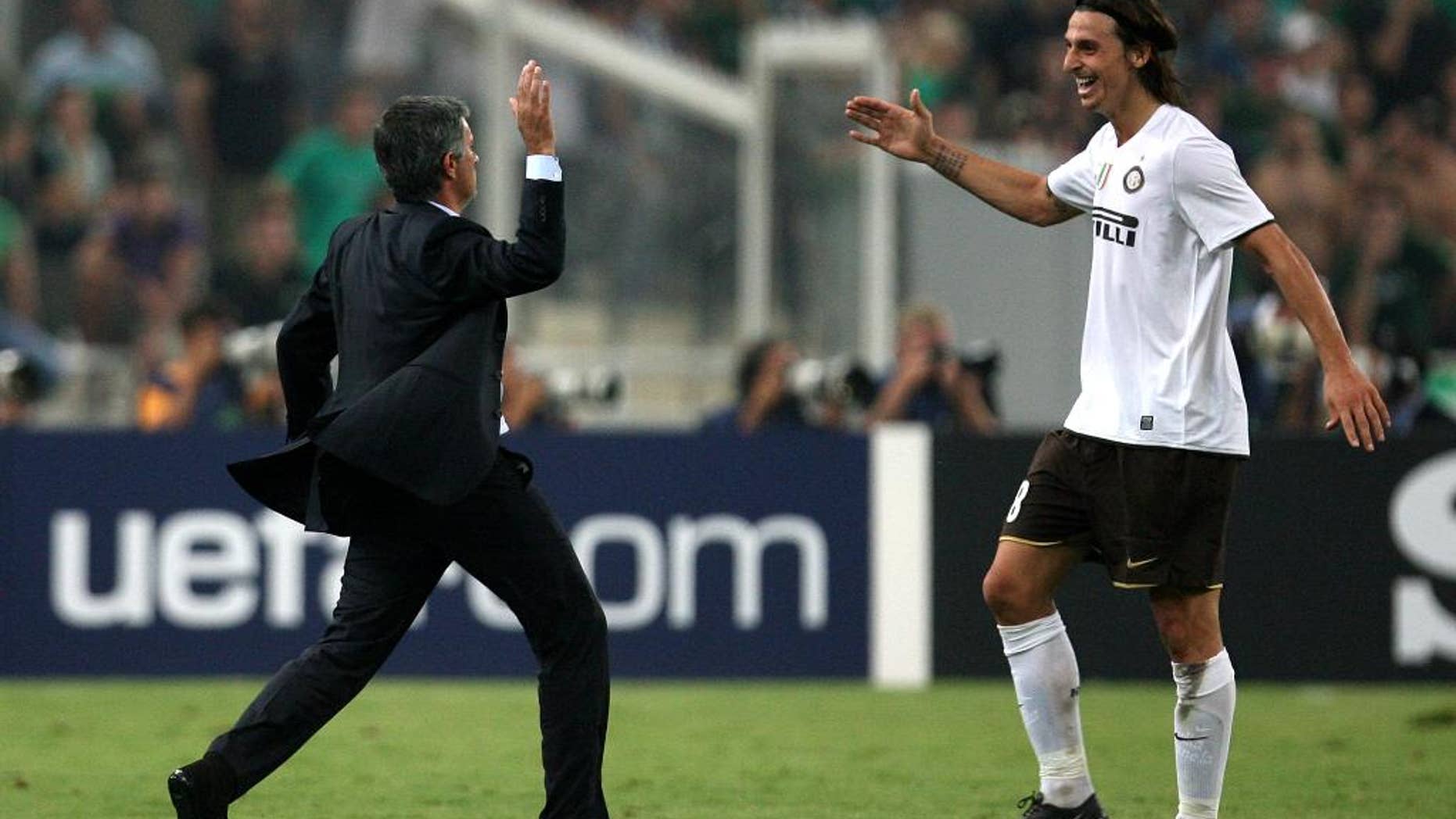 FILE - In this Tuesday, Sept. 16, 2008 file photo, Inter Milan coach Jose Mourinho congratulates Zlatan Ibrahimovic, right, after scoring against Panathinaikos, during a Champions League soccer match at the Olympic stadium of Athens. Zlatan Ibrahimovic said on his official social media accounts Wednesday, June 30, 2016 that his next club will be Manchester United. (AP Photo/Thanassis Stavrakis, File)