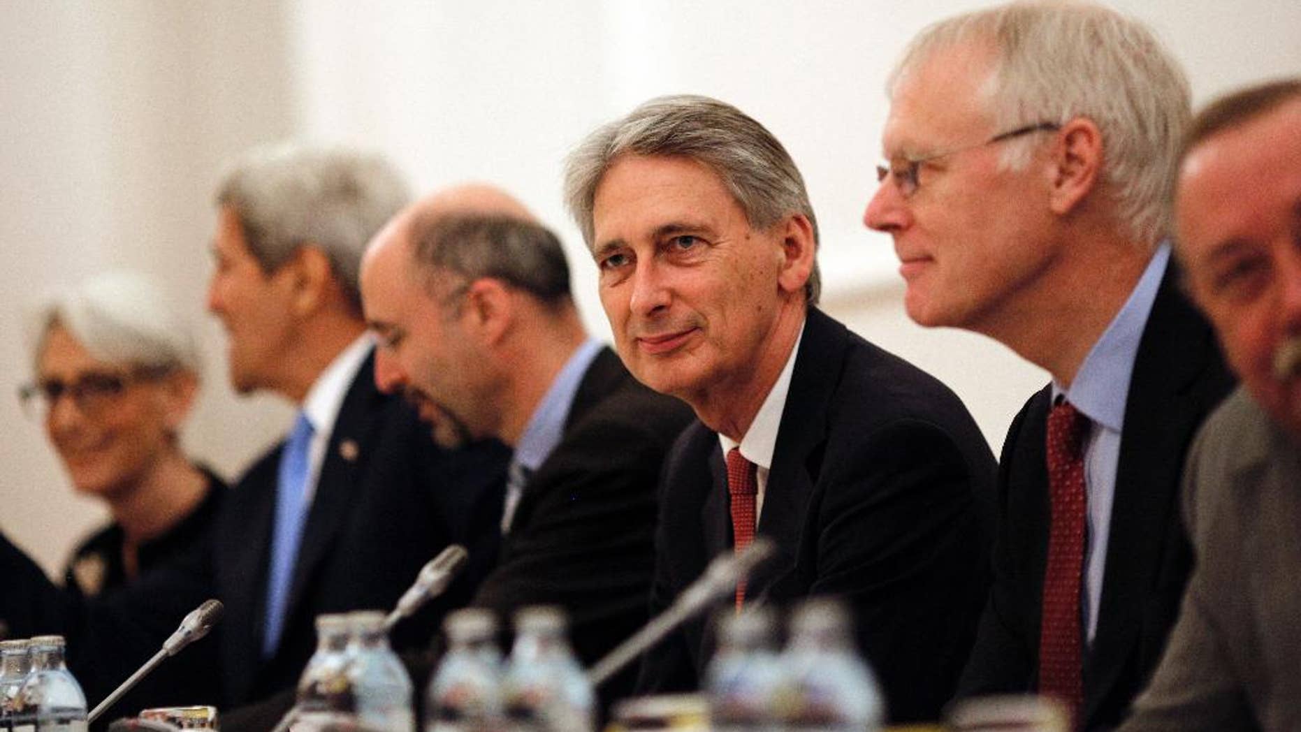 British Foreign Secretary Philip Hammond, centre, attends a meeting with foreign ministers and representatives of United States, France, Germany, China, Russia and the European Union during the current round of nuclear talks with Iran, being held in Vienna, Austria July 10, 2015. U.S. Secretary of State John Kerry, 2nd left, and U.S. Under Secretary for Political Affairs Wendy Sherman, left. U.S. Secretary of State John Kerry urged Iran to make the “tough political decisions” needed to reach an agreement but Iranian Foreign Minister Mohammad Javad Zarif accused major powers on Friday of backtracking on previous pledges and throwing up new "red lines" at nuclear talks. (Carlos Barria/Pool via AP)