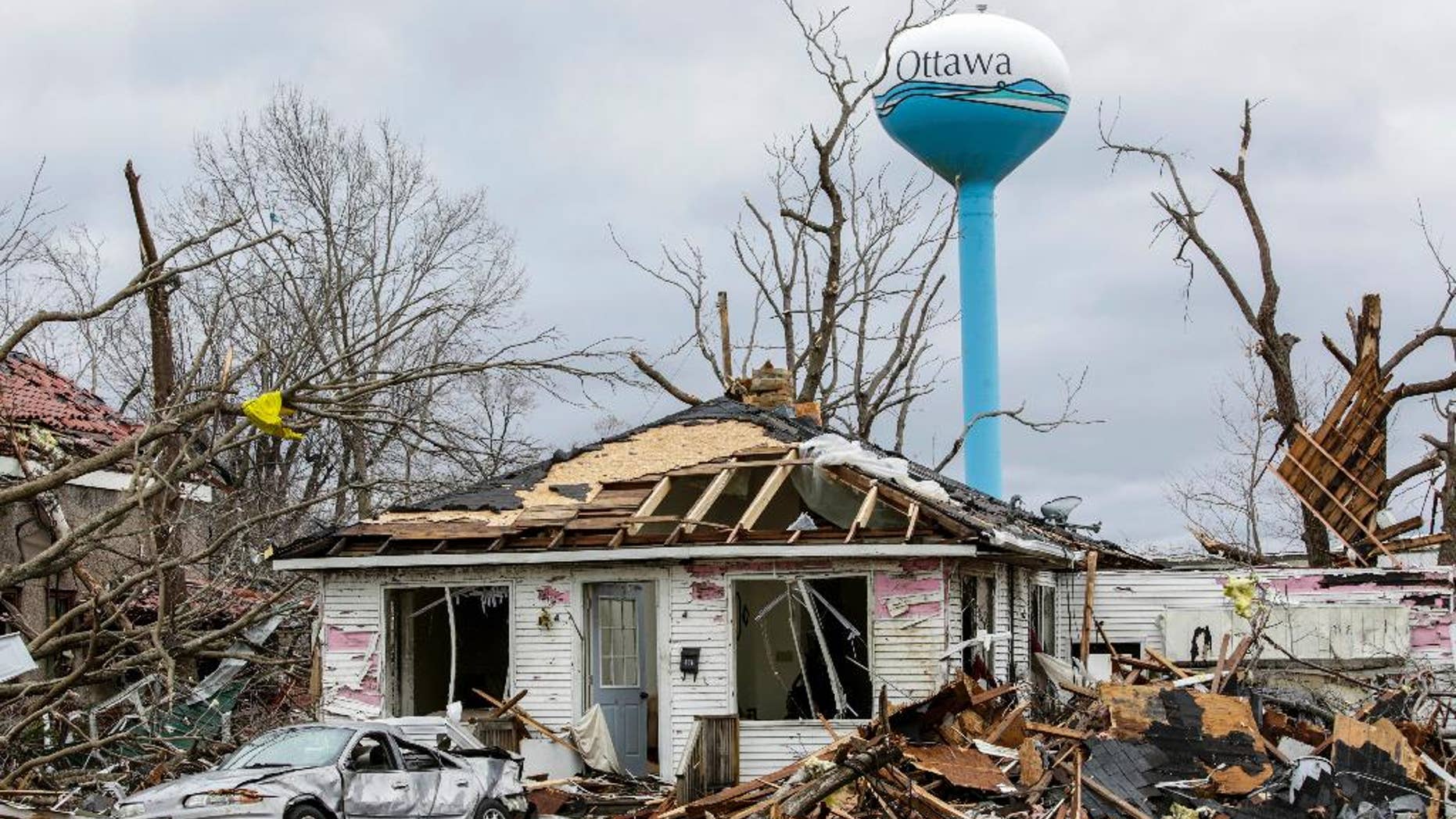 Debbie Loughridge's damaged home and car are seen among debris in Naplate, Ill., Wednesday, March 1, 2017. Loughridge and her son rode out the storm in the bathtub. "All I heard was the wind and the breaking glass. Like an explosion of glass," she said. In the small community of Naplate, next to Ottawa, about a quarter of the roughly 200 homes were damaged, Fire Chief John Nevins said. (AP Photo/Teresa Crawford)
